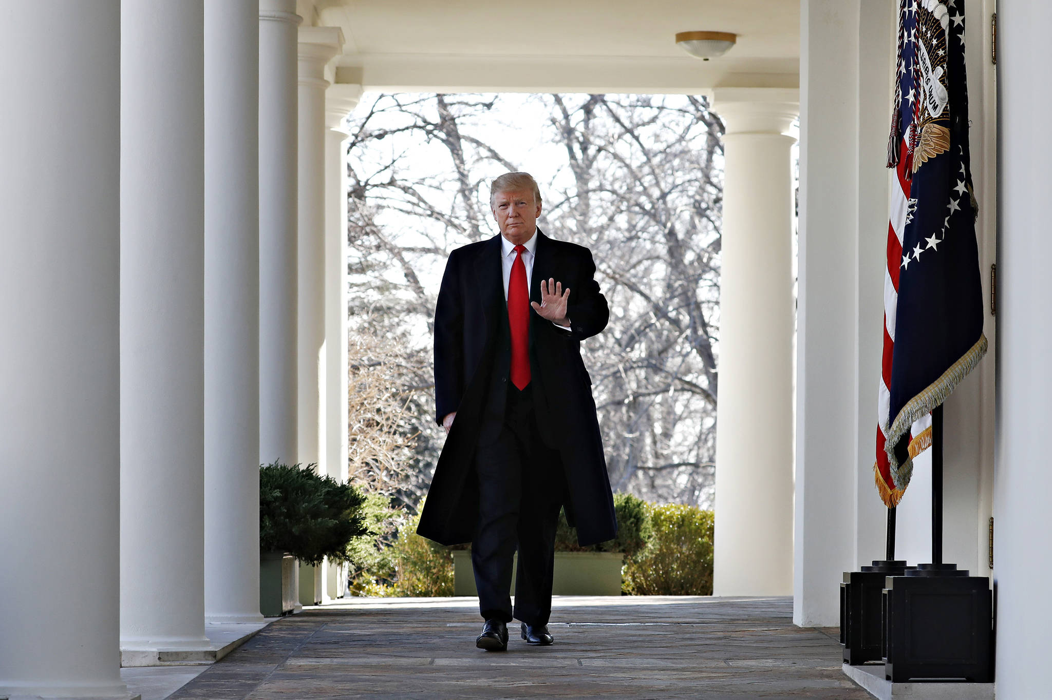 President Donald Trump waves as he walks through the Colonnade from the Oval Office of the White House on arrival to announce a deal to temporarily reopen the government, Friday, Jan. 25, 2019, from the Rose Garden of the White House in Washington. (AP Photo | Jacquelyn Martin)
