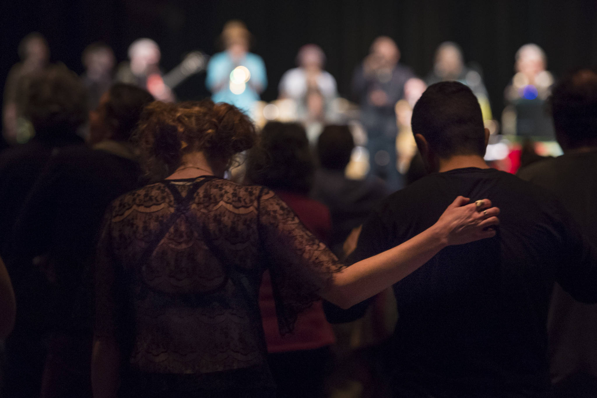 Audience members stand to a prayer song performed by Khu.eex’ at Centennial Hall on Monday, Jan. 28, 2019. (Michael Penn | Juneau Empire)
