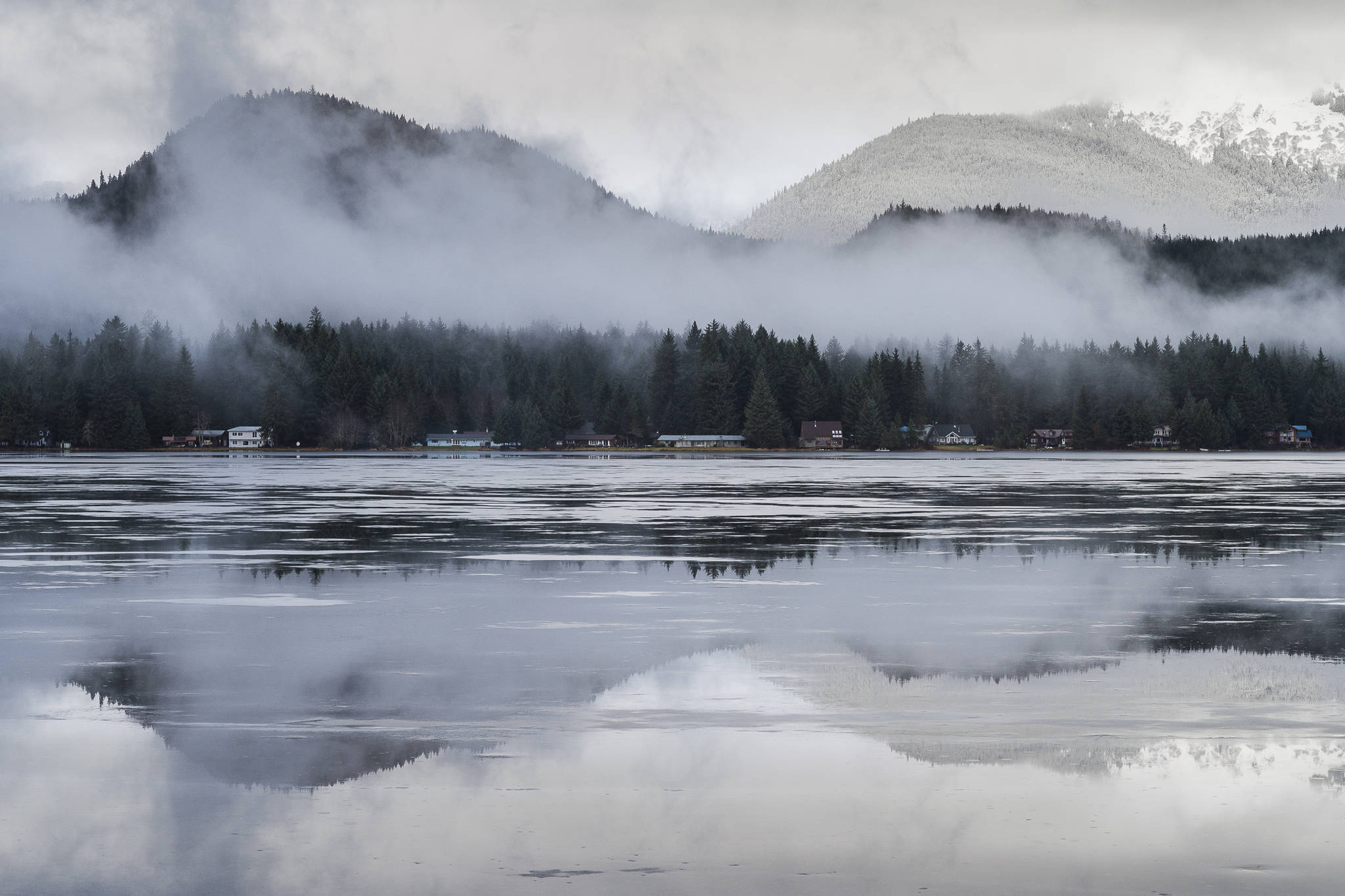 Fresh rainwater sits on top of the ice at Auke Lake on Wednesday, Jan. 2, 2019. The National Weather Service expects snow and cold temperatures to be in Juneau’s future. (Michael Penn | Juneau Empire File)