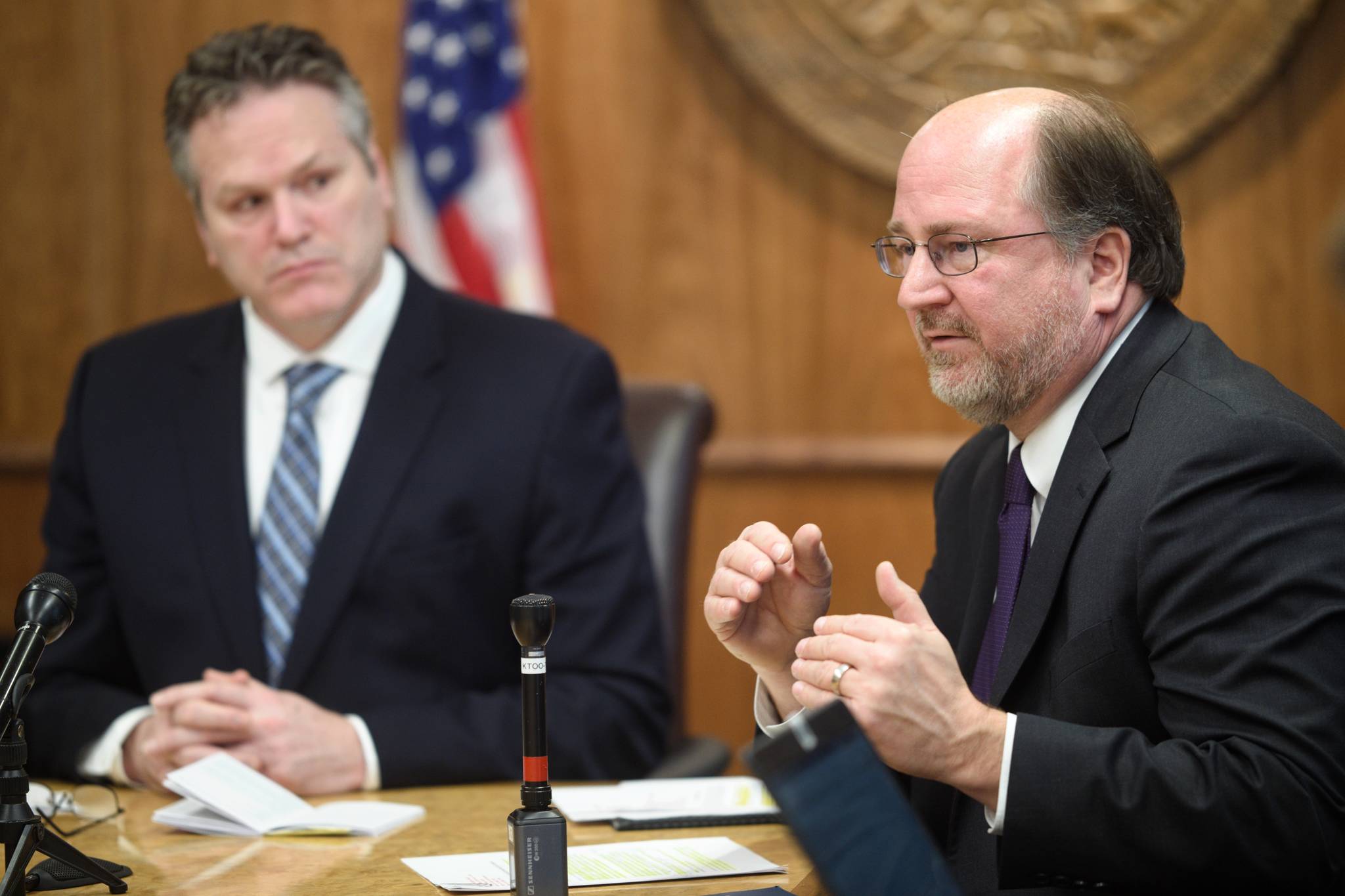 Gov. Mike Dunleavy, left, listens as Attorney General Kevin Clarkson describes three constitutional amendments that would be a foundation of his administration’s fiscal plan during a press conference at the Capitol on Wednesday, Jan. 30, 2019. (Michael Penn | Juneau Empire)
