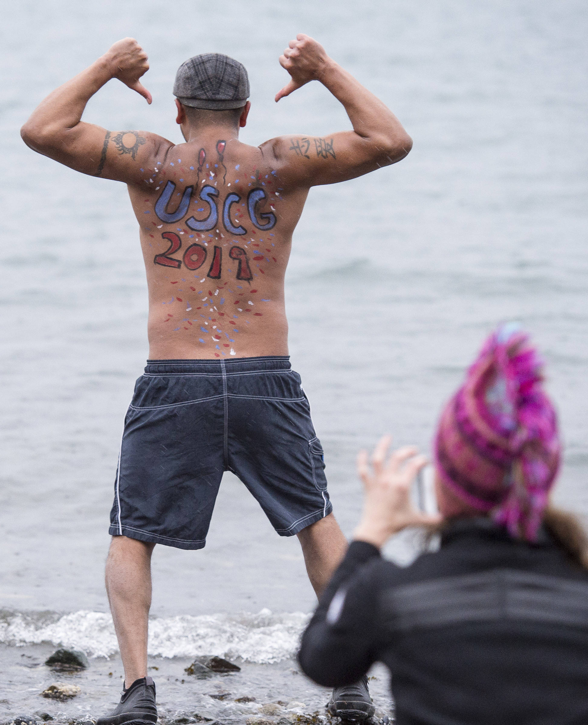 Marvin Pena poses for a picture before taking to the frigid waters at Auke Bay Recreation Area for the annual Juneau Polar Bear Dip on Tuesday, Jan. 1, 2019. Nearly 200 people took the plunge to start off the new year. (Michael Penn | Juneau Empire)