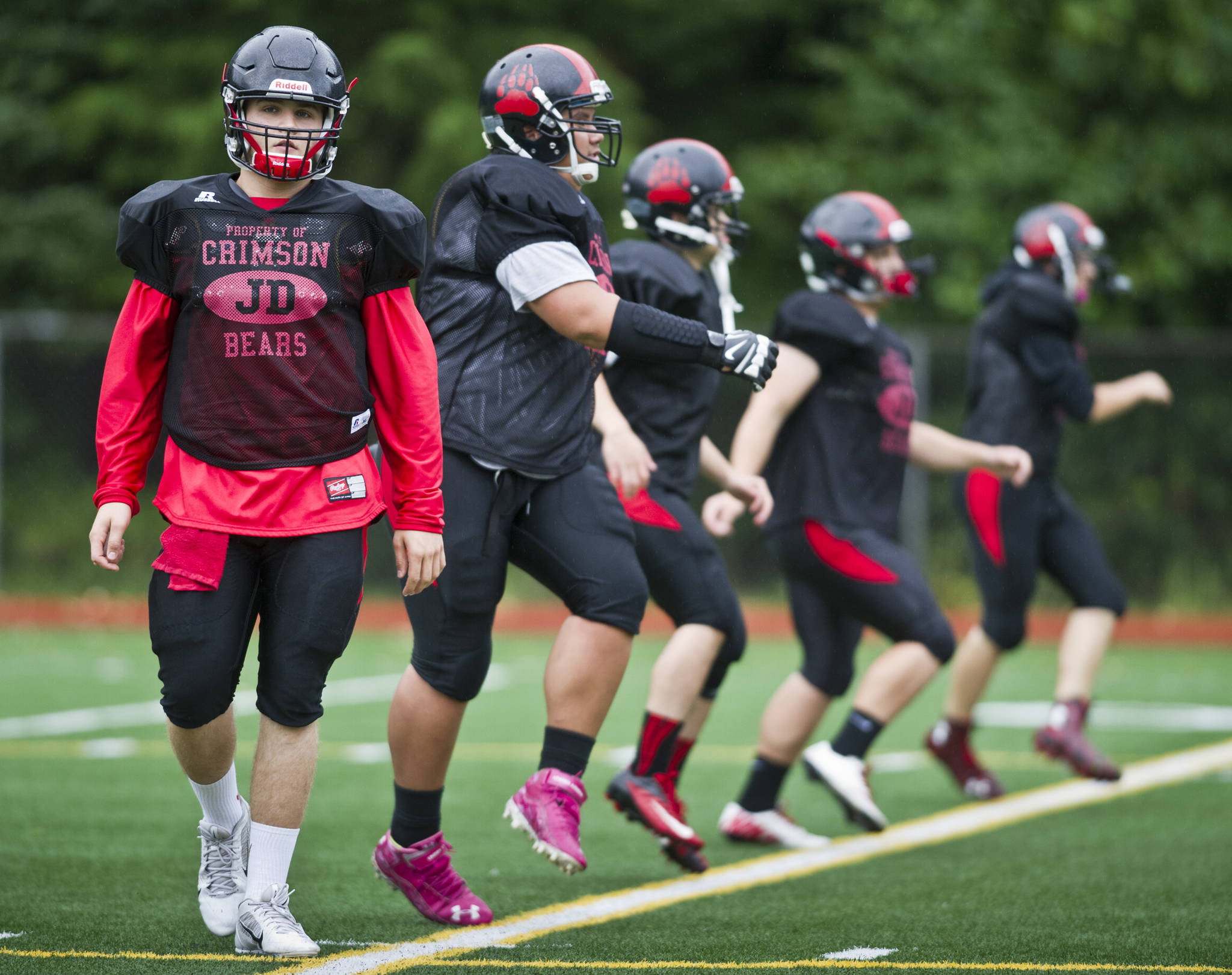 Hunter Hickok leads warmup drills during Juneau-Douglas High School varsity football practice in August of 2015. Hickok was twice named Southeast Conference Defensive Player Of The Year during his time with the Crimson Bears from 2012-2015. (Michael Penn | Juneau Empire File)