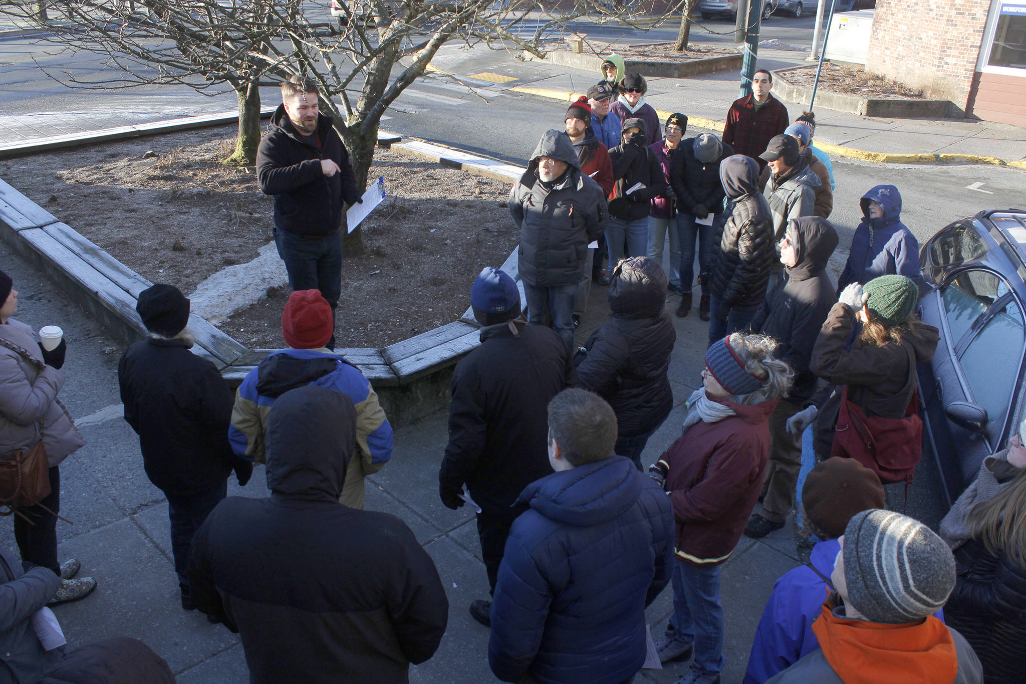 Zane Jones from MRV Architects speaks to attendees at a Blueprint Downtown walking tour on Saturday. Attendees shared their thoughts and experiences about downtown business, housing and public safety. (Alex McCarthy | Juneau Empire)
