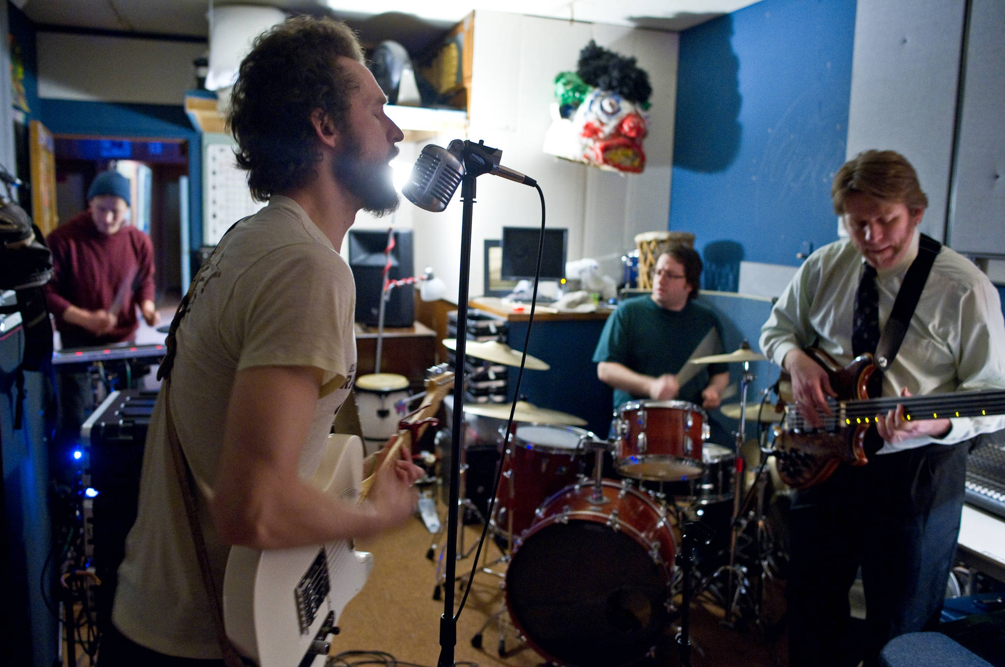 Nickolas Wagner, drums, left, George Kuhar, guitar and lead vocals, Jason Messing, drums and Simon Taylor, bass, right, of Playboy Spaceship rehearse Tuesday. Not shown is Bridget Cross Kuhar, keyboards. (Michael Penn | Juneau Empire File)