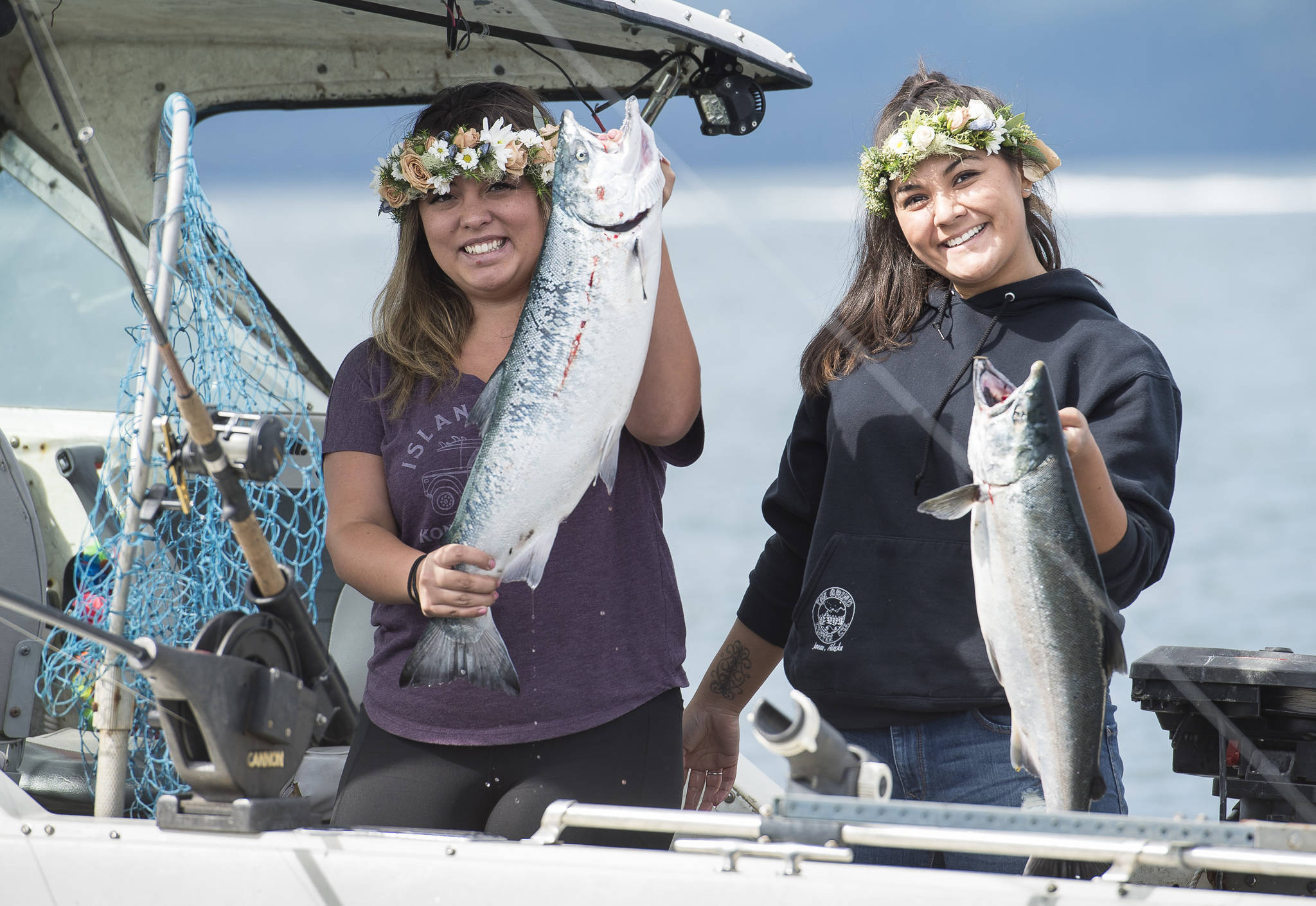 Tesla Cox, left, and Deanne Fuller on the Lil’ Mermaid show their silver salmon during the 72nd Annual Golden North Salmon Derby on Friday, August 17, 2018, sponsored by the Territorial Sportsmen. (Michael Penn | Juneau Empire)