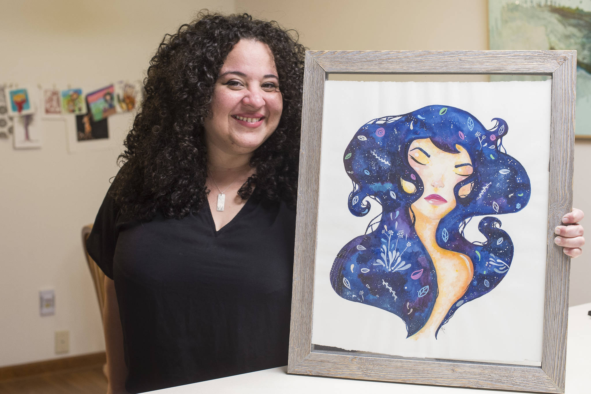 Glo Ramirez shows off her artwork at her Juneau apartment on Monday, Dec. 31, 2018. (Michael Penn | Juneau Empire)