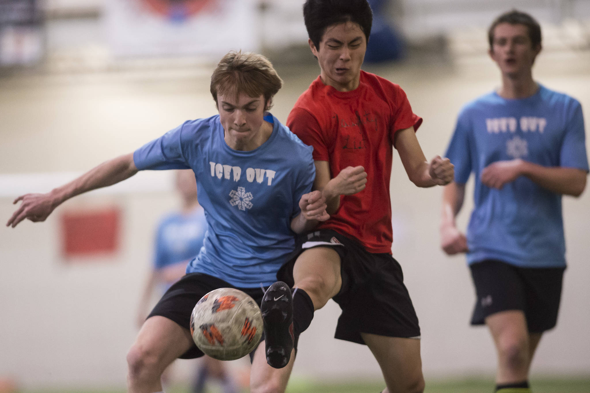 Iced Out’s Kanon Goetz, left, battles Naughty List’s Chaehun Yi in the finals of the high school division at the annual Holiday Cup Soccer Tournament at the Wells Fargo Dimond Park Field House on Monday, Dec. 31, 2018. Iced Out won 8-2. (Michael Penn | Juneau Empire)