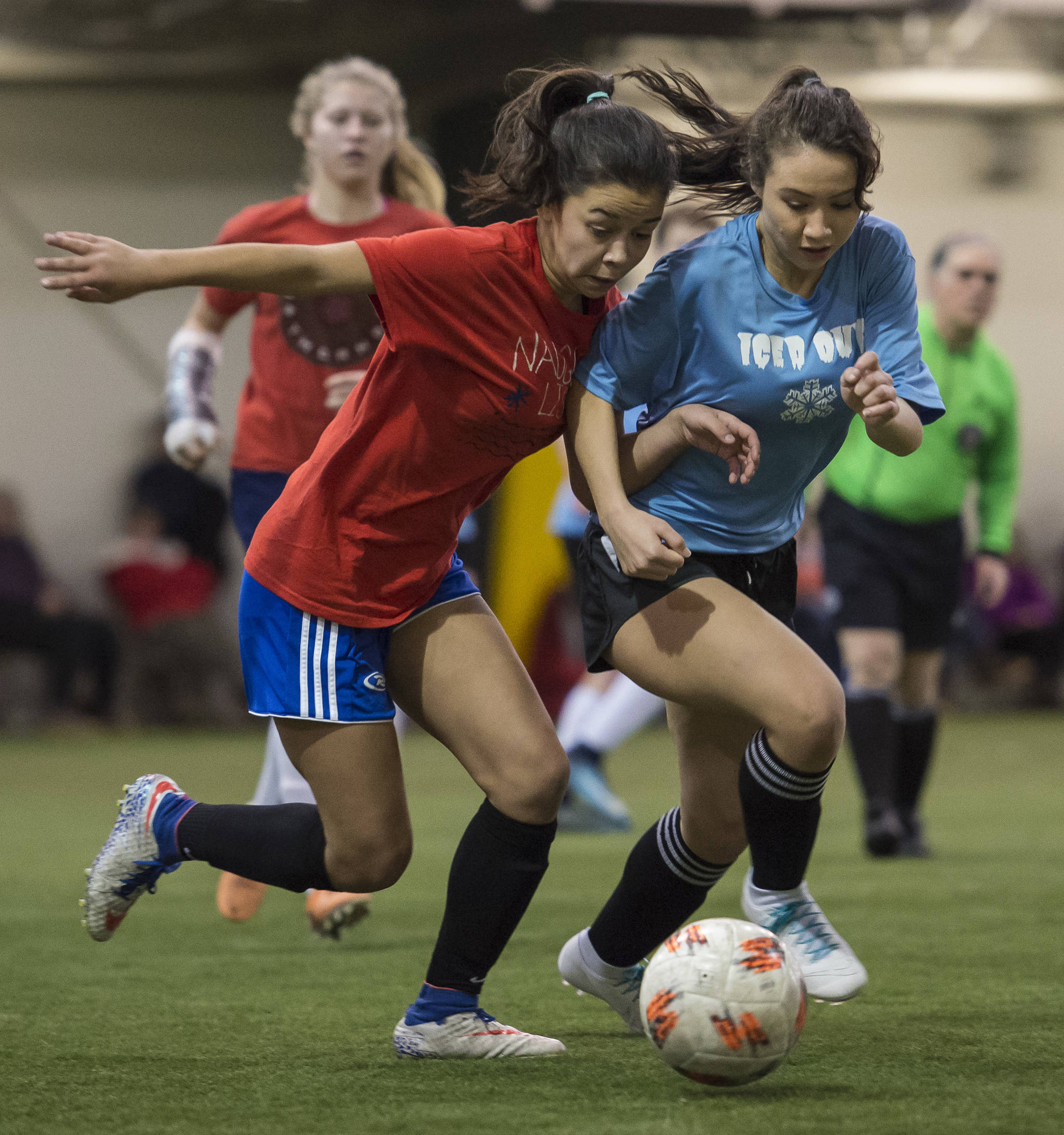 Iced Out’s Brianna Jokerst competes against Naughty List’s Blake Plummer in the finals of the high school division at the annual Holiday Cup Soccer Tournament at the Wells Fargo Dimond Park Field House on Monday, Dec. 31, 2018. Iced Out won 8-2. (Michael Penn | Juneau Empire)