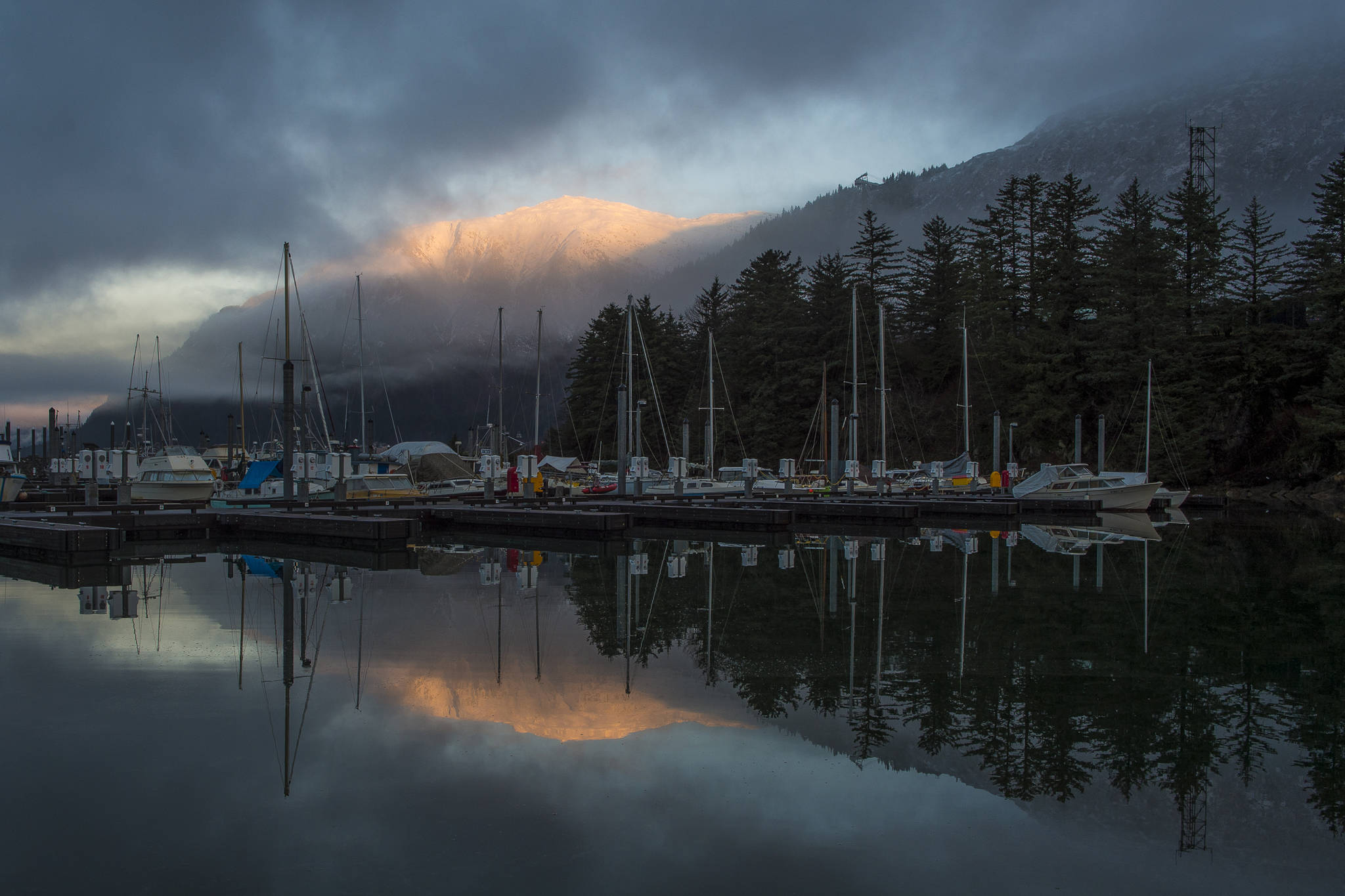 Mount Juneau catches the first rays of sunrise as seen from the Mike Pusich Douglas Boat Harbor on Thursday, Jan. 3, 2019. (Michael Penn | Juneau Empire)