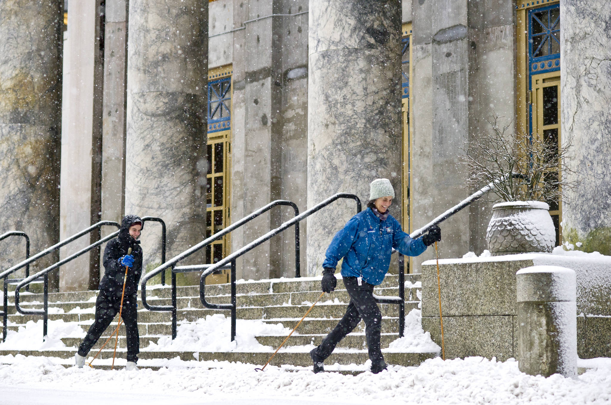 In this Dec. 14, 2015 photo, Jan Rutherdale and her daughter, Isabel Bush, ski past the Capitol. (Michael Penn | Juneau Empire File)