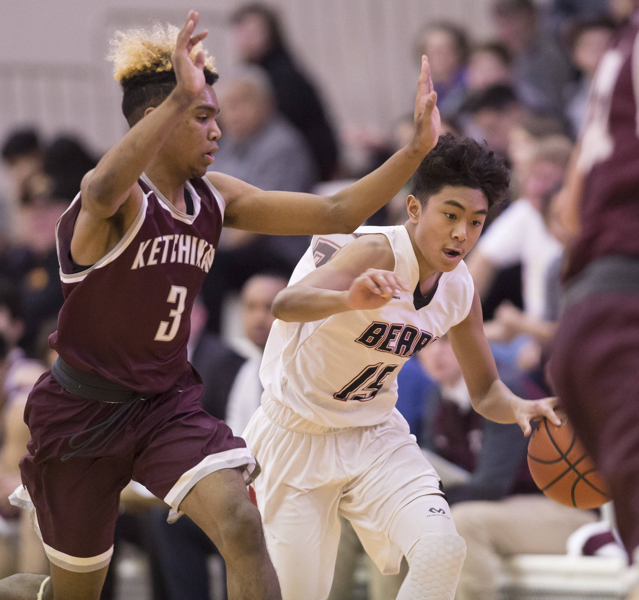 Juneau-Douglas’ Israel Yadao, right, drives against Ketchikan’s Marcus Lee at JDHS during a conference win last February. Lee earned first team all-state honors last season. (Michael Penn | Juneau Empire File)