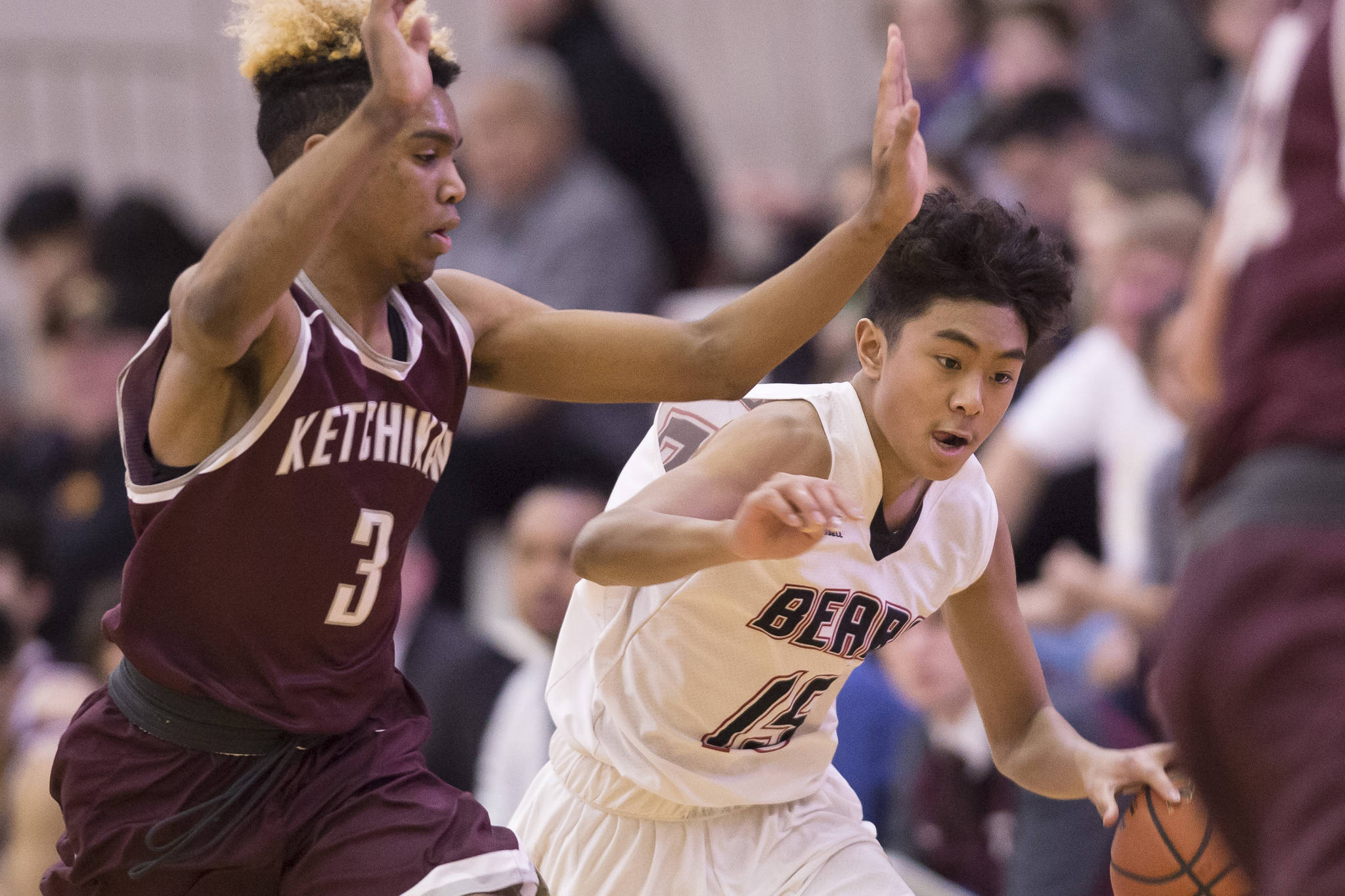 Juneau-Douglas’ Israel Yadao, right, drives against Ketchikan’s Marcus Lee at JDHS during a conference win last February. Lee earned first team all-state honors last season. (Michael Penn | Juneau Empire File)