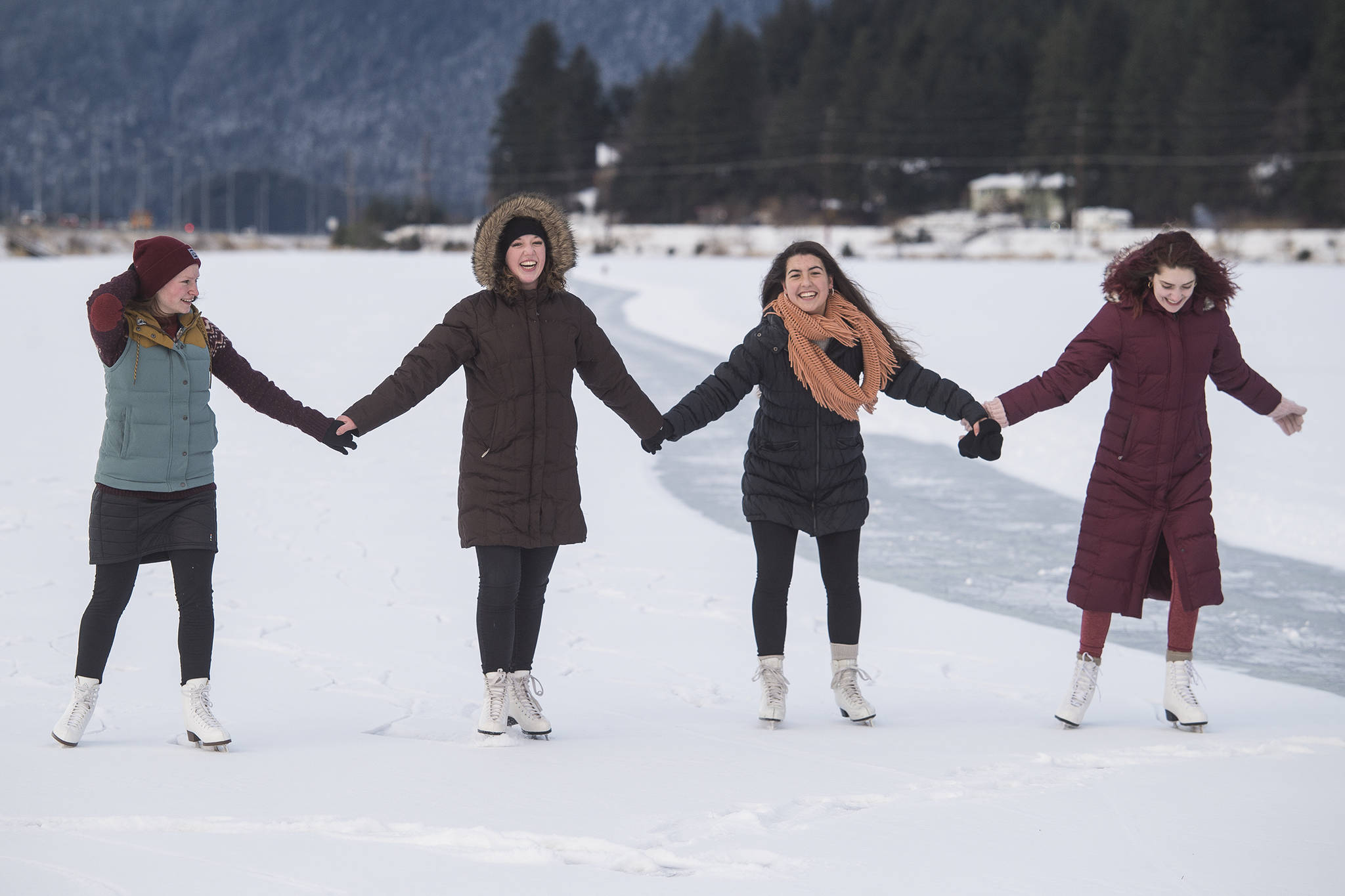 Elizabeth Ramseth, left, Bethany Bibb, Maria Jsustartari and Lydia Smith, right, take time out during the lunch hour to skate at Twin Lakes on Wednesday, Jan. 8, 2019. (Michael Penn | Juneau Empire)