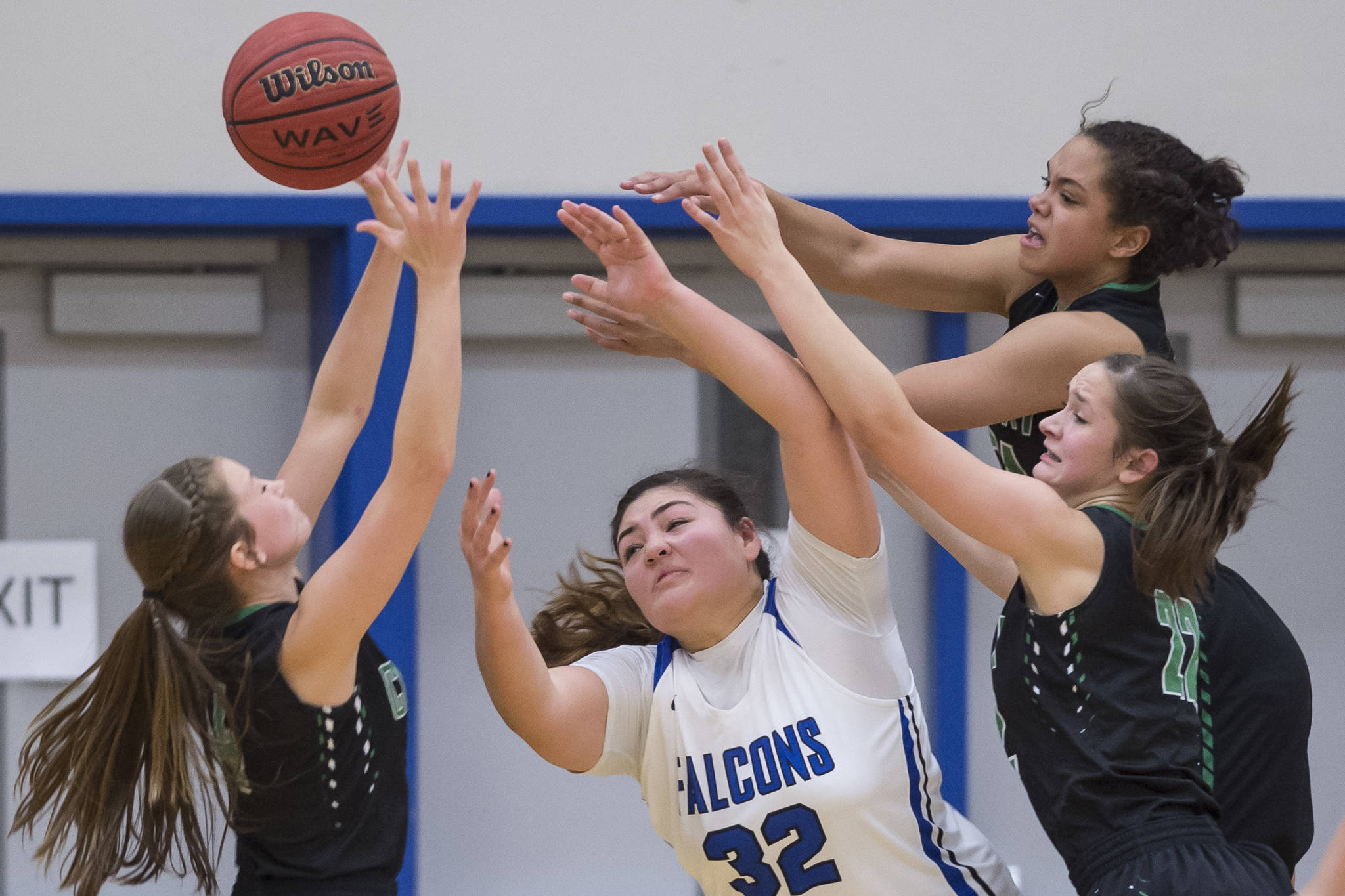 Thunder Mountain’s Nina Fenumiai is out-rebounded by Colony’s Hannah Duguid, left, Indiya Clarke, top, and Vivian Sonnenber at TMHS on Friday, Jan. 11, 2019. Colony won 58-28. (Michael Penn | Juneau Empire)