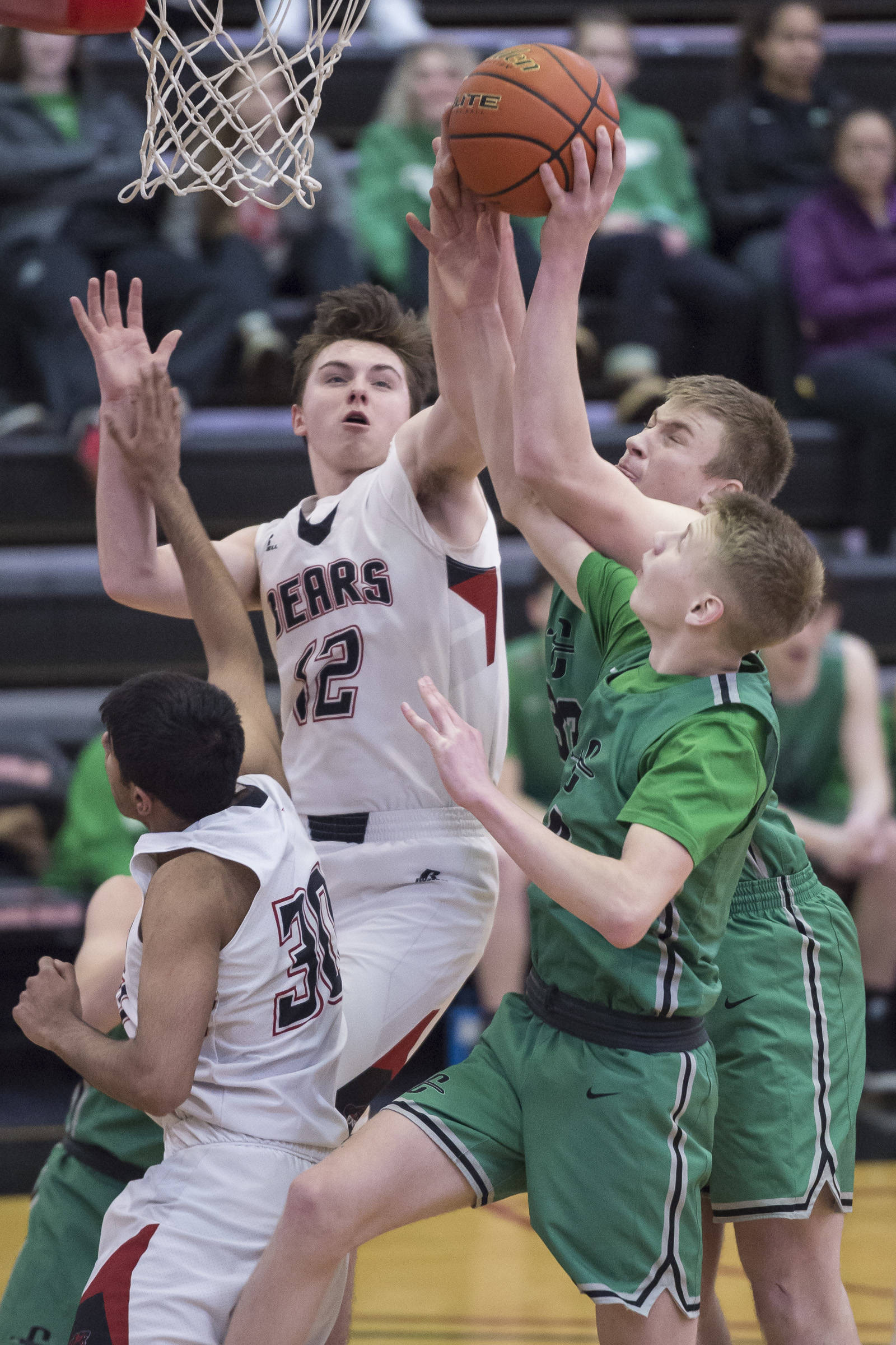 Juneau-Douglas’ Brock McCormick, left, goes up for a rebound against Colony’s Wyatt Baker and Colton Spencer at JDHS on Thursday, Jan. 10, 2019. Colony won 66-40. (Michael Penn | Juneau Empire}