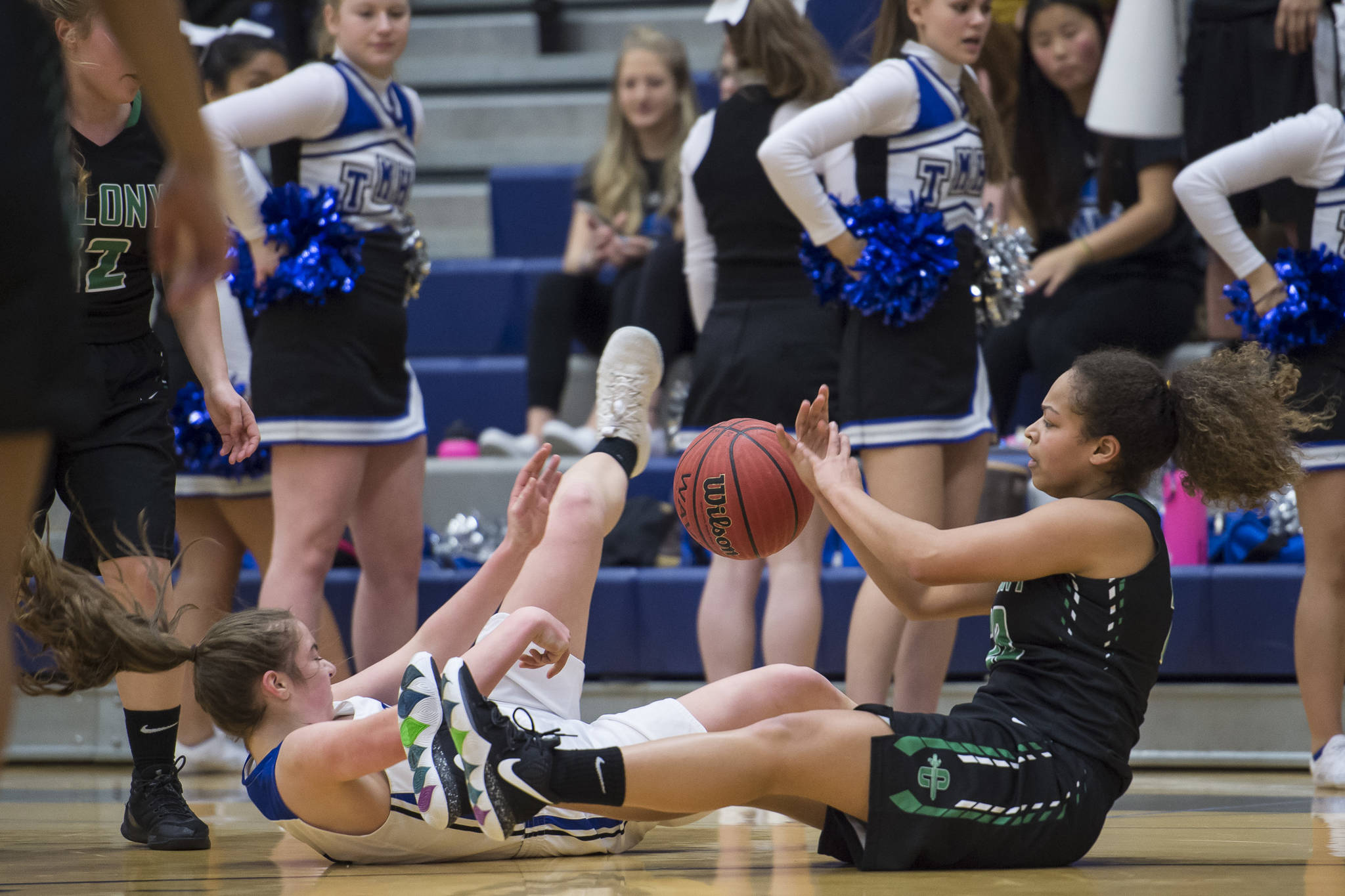 Thunder Mountain’s Samantha Dilley, left, and Colony’s Kali Bull go to the floor after a loose ball at TMHS on Friday, Jan. 11, 2019. Colony won 58-28. (Michael Penn | Juneau Empire)