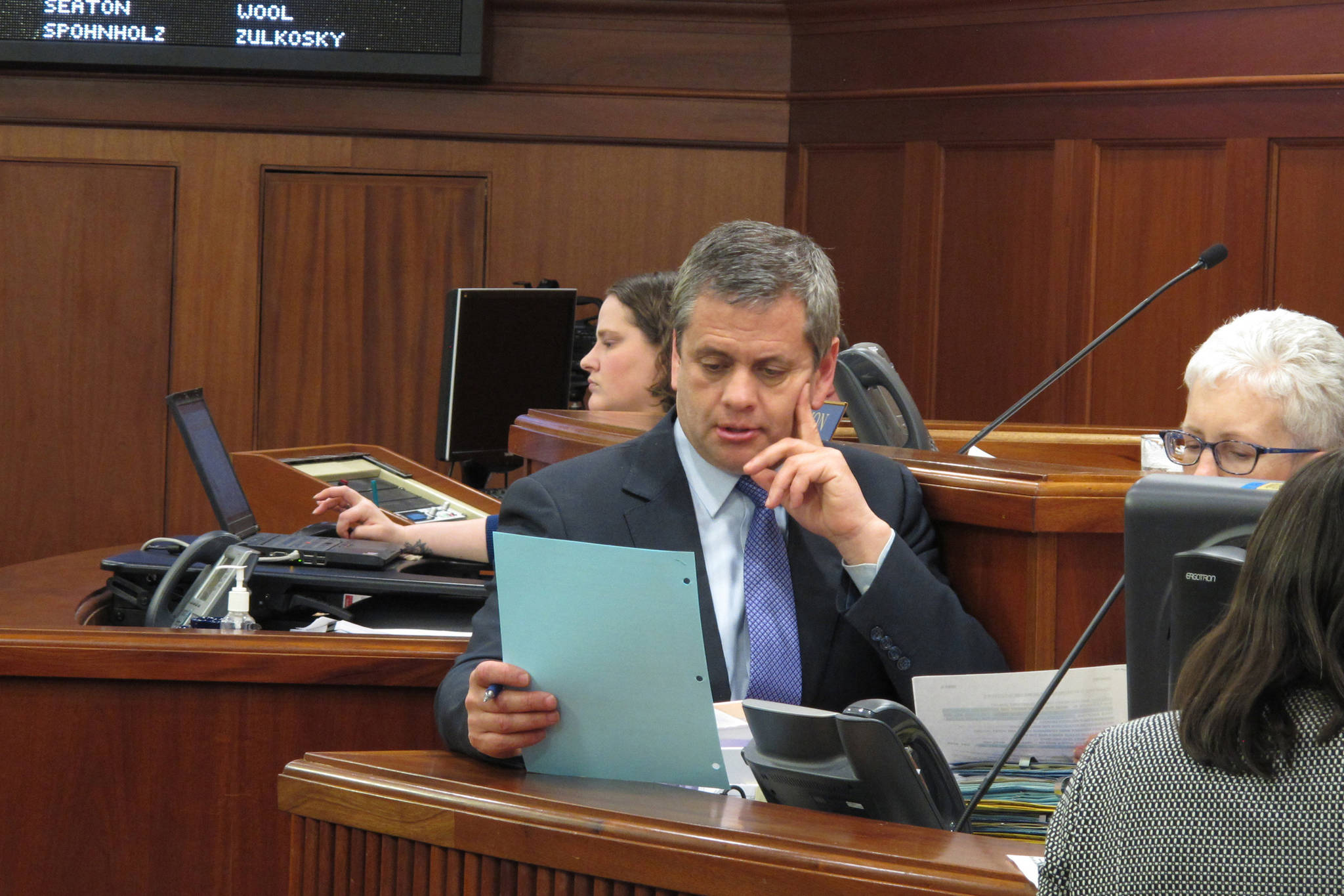 In this May 12, 2018 photo, Alaska House Minority Leader Chris Tuck looks over a document during a break in the Alaska House floor session in Juneau, Alaska. (Becky Bohrer | Associated Press File)