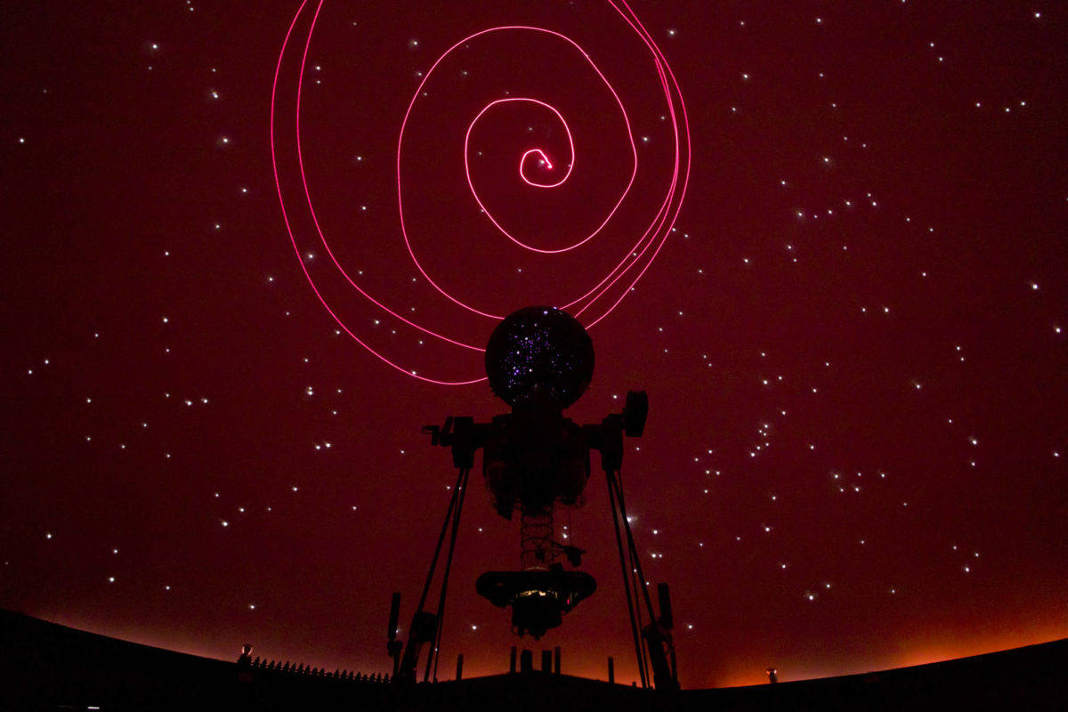 Marie Drake Planetarium volunteer Clark Branch uses a laser pointer to circle the North Star during a monthly talk on the night sky. (Michael Penn | Juneau Empire File)