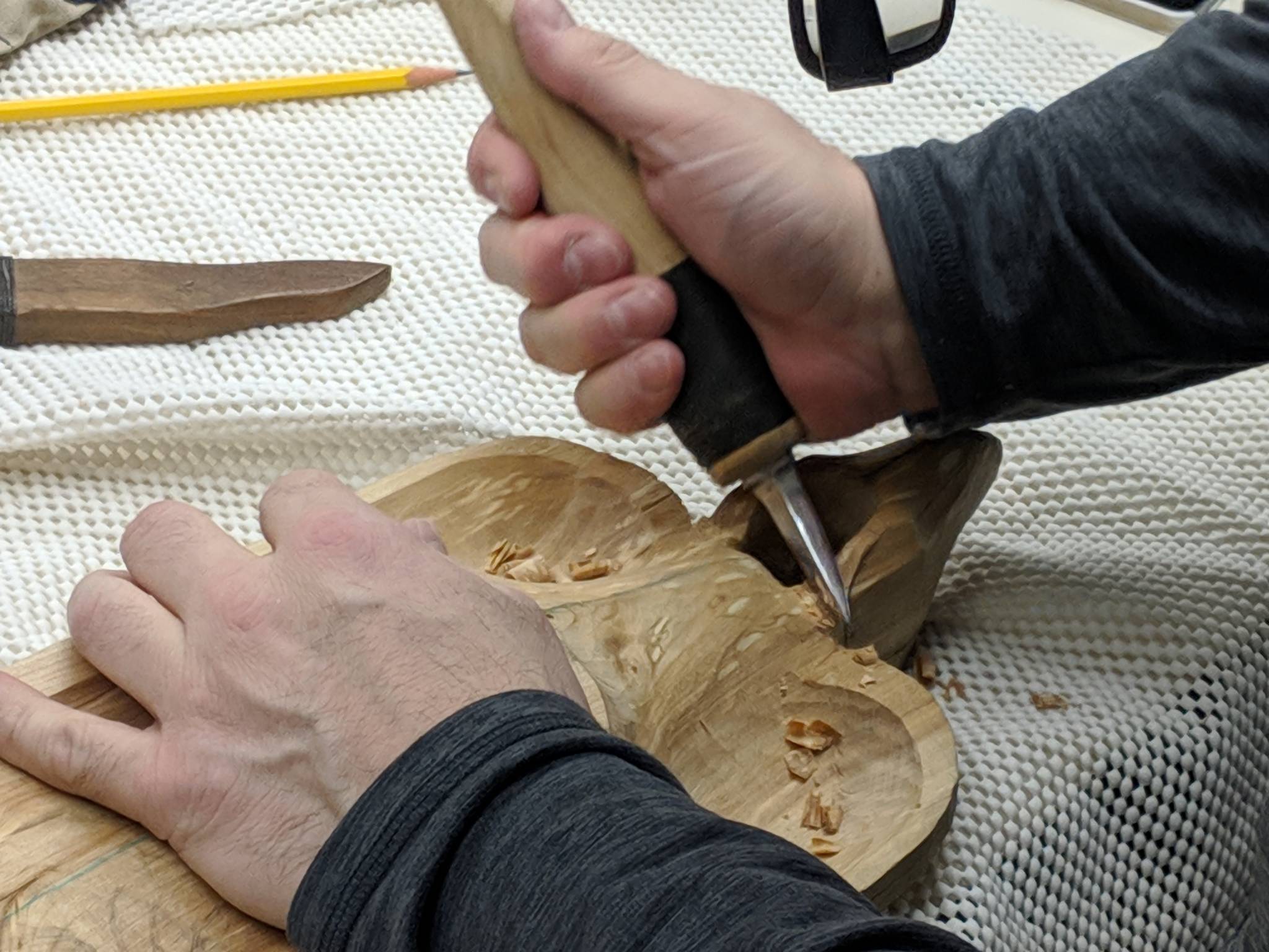 Doug Gray works on a lovebirds bowl Saturday, Jan. 12, 2019. Gray has been carving since he came to Juneau from Sitka in the early ’00s. (Ben Hohenstatt | Capital City Weekly)