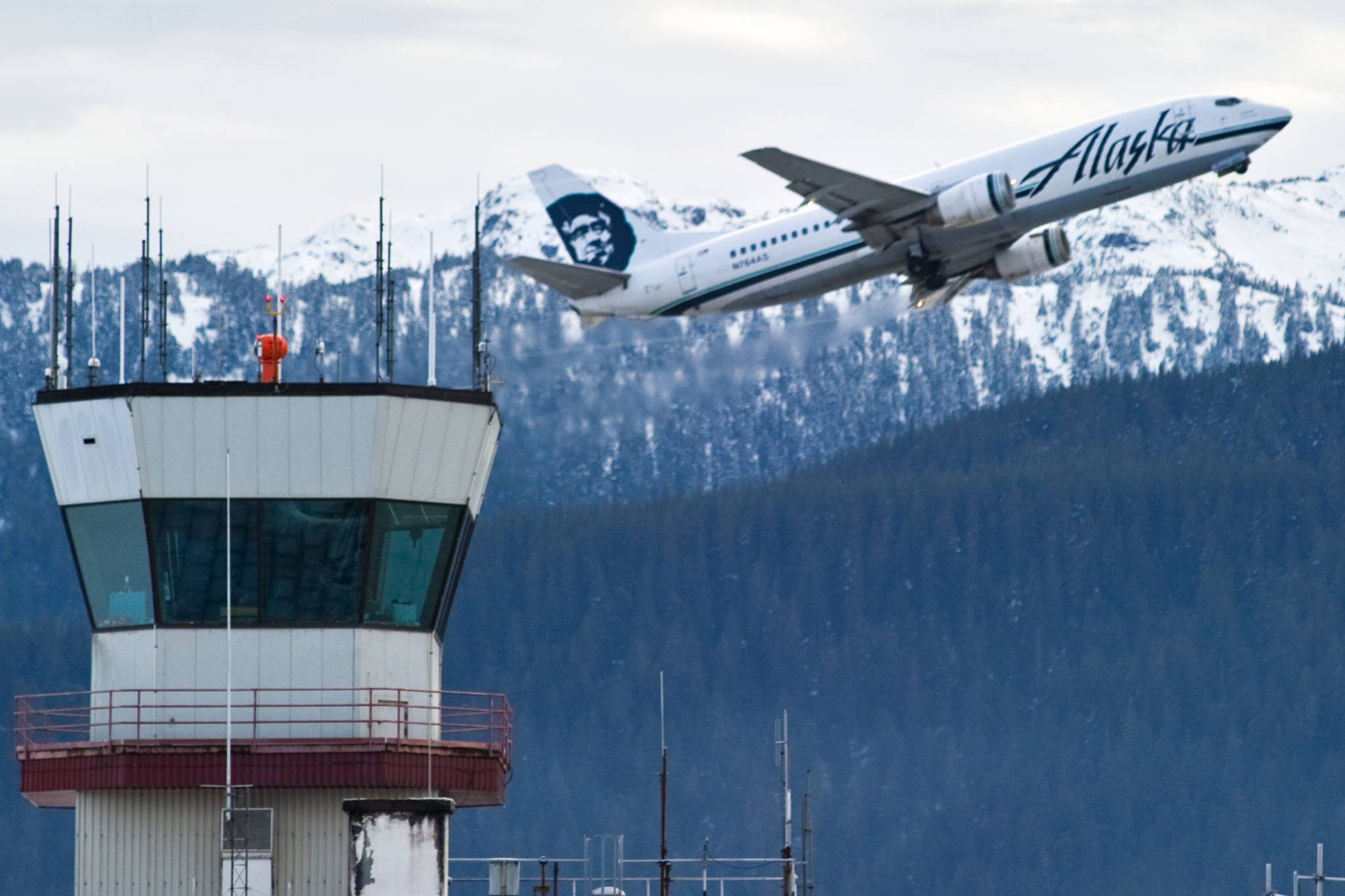 In this December 2014 photo, an Alaska Airlines jet lifts off from the Juneau International Airport. (Michael Penn | Juneau Empire File)