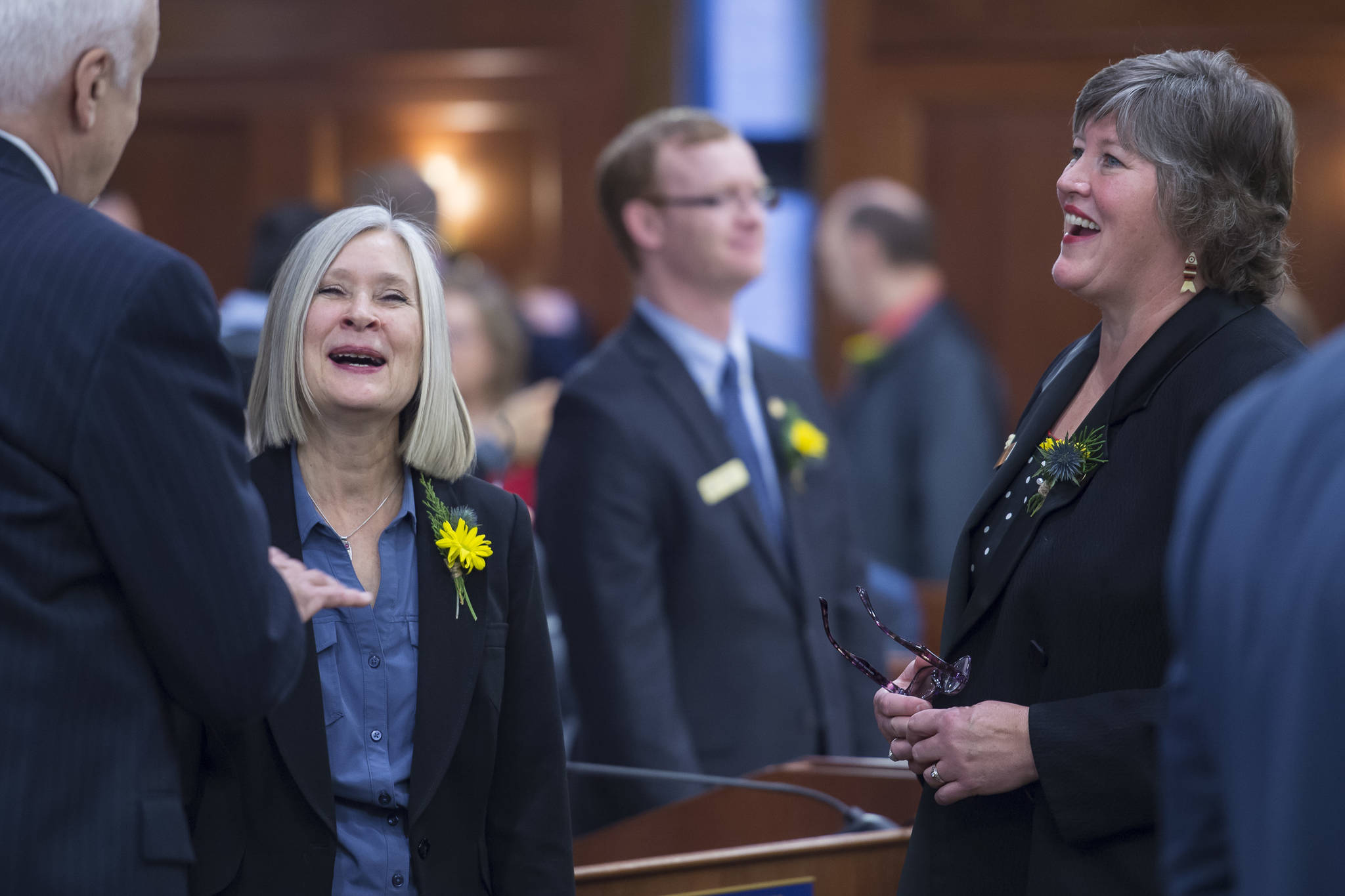Rep. Andi Story, D-Juneau, center, and Rep. Sara Hannan, D-Juneau, share a laugh with Rep. Bart LeBon, R-Fairbanks, on the opening day of the 31st Session of the Alaska Legislature on Tuesday, Jan. 15, 2019. (Michael Penn | Juneau Empire)