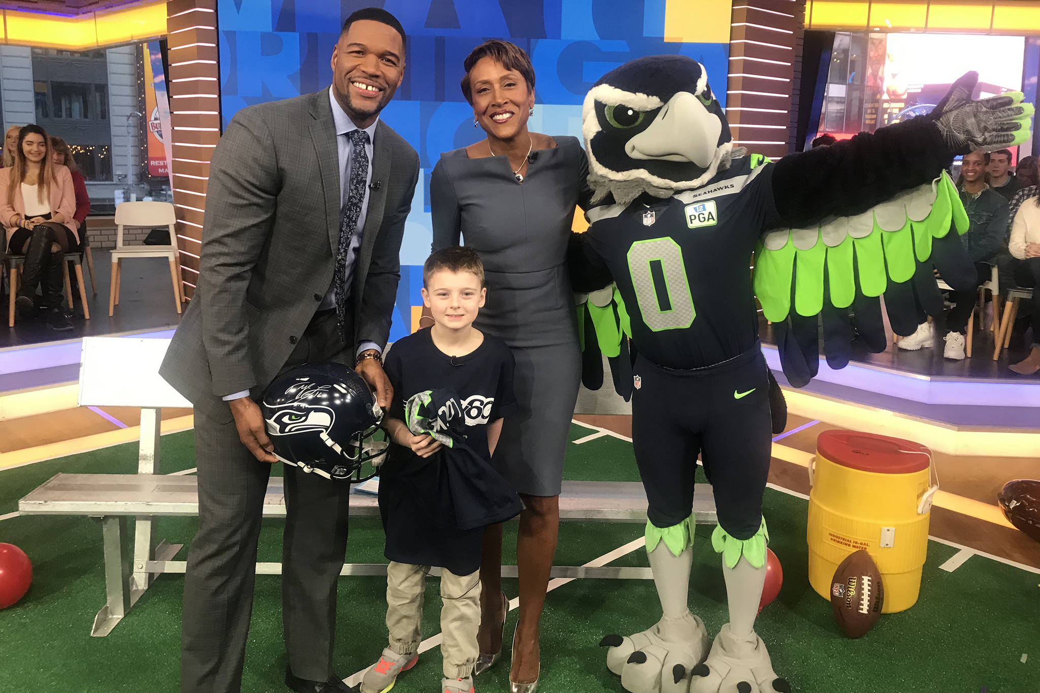 Juneau’s Camdyn Clancy, second from left, holds signed Seattle Seahawks Tyler Lockett jersey with Good Morning America hosts Michael Strahan and Robin Roberts and Seattle Seahawks mascot Blitz after a live taping of the show at New York City’s Times Square Studios on Tuesday, Jan. 17, 2019. Clancy, 8, will be receiving an all-expense paid trip to Super Bowl LII as the winner of the NFL PLAY 60 Super Kid contest. (Courtesy Photo | Hannah Clancy)