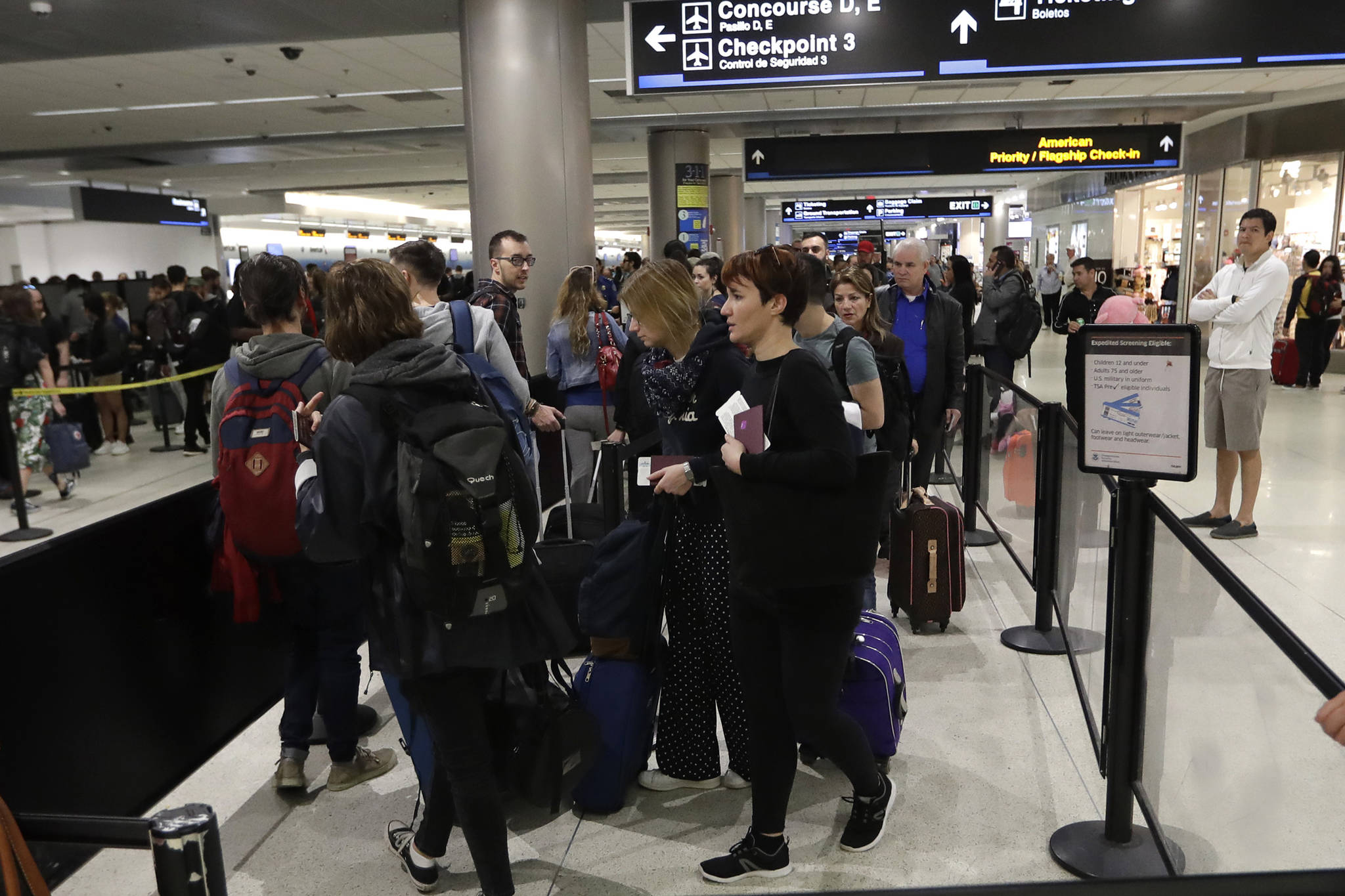 Passengers wait in line at a security checkpoint at Miami International Airport, Friday, Jan. 18, 2019, in Miami. (Lynne Sladky | Associated Press)