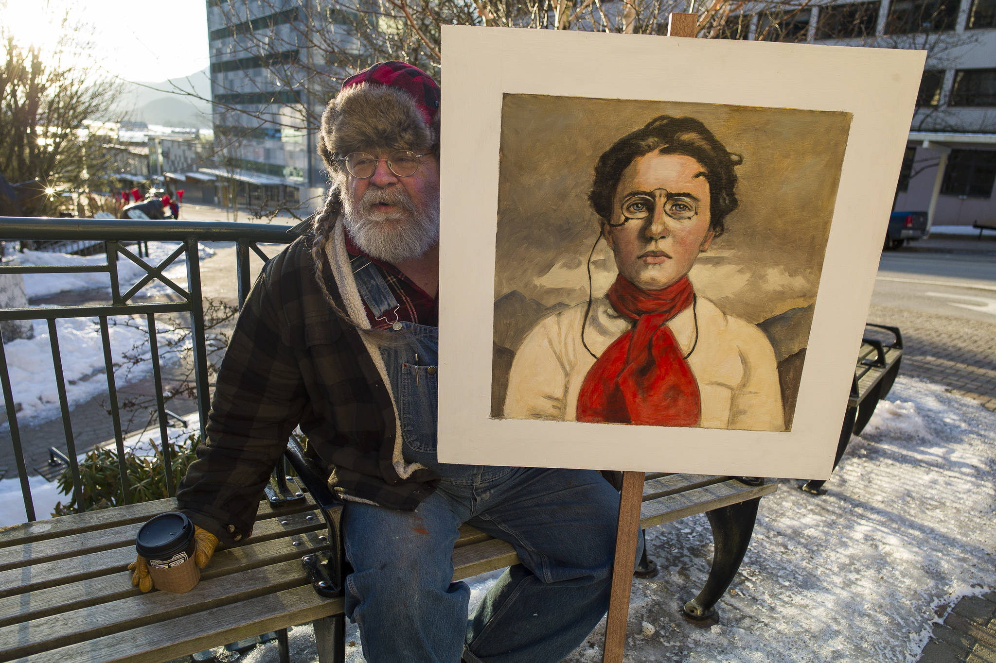 David Woodie holds a painting of Emmy Goldman before the start of the Women’s March on Juneau in front of the Alaska State Capitol on Saturday, Jan. 19, 2019. (Michael Penn | Juneau Empire)