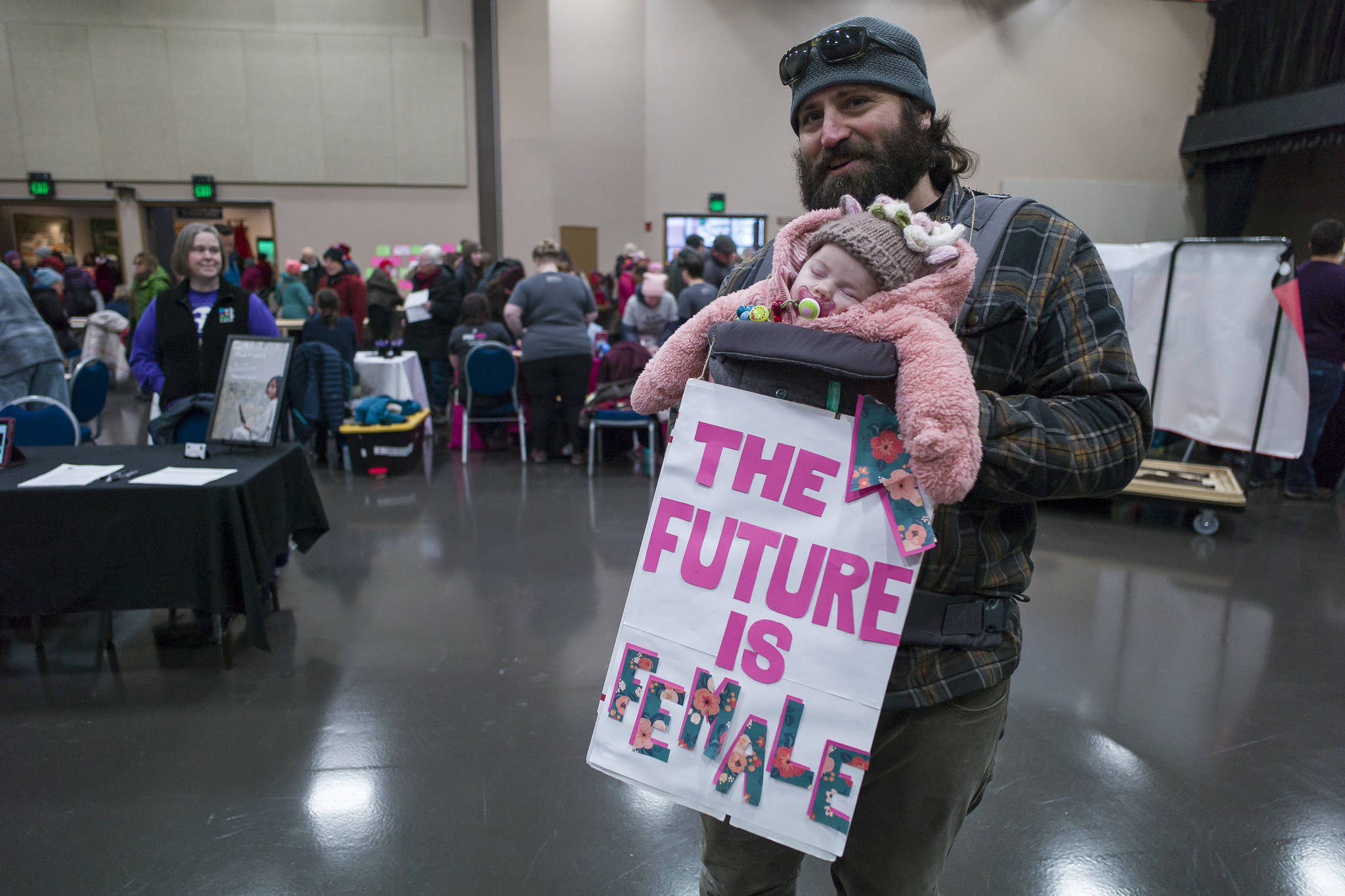 Frank Lambert stops by Centennial Hall with his three-month-old daughter, Frankie, after the Women’s March on Juneau on Saturday, Jan. 19, 2019. (Michael Penn | Juneau Empire)