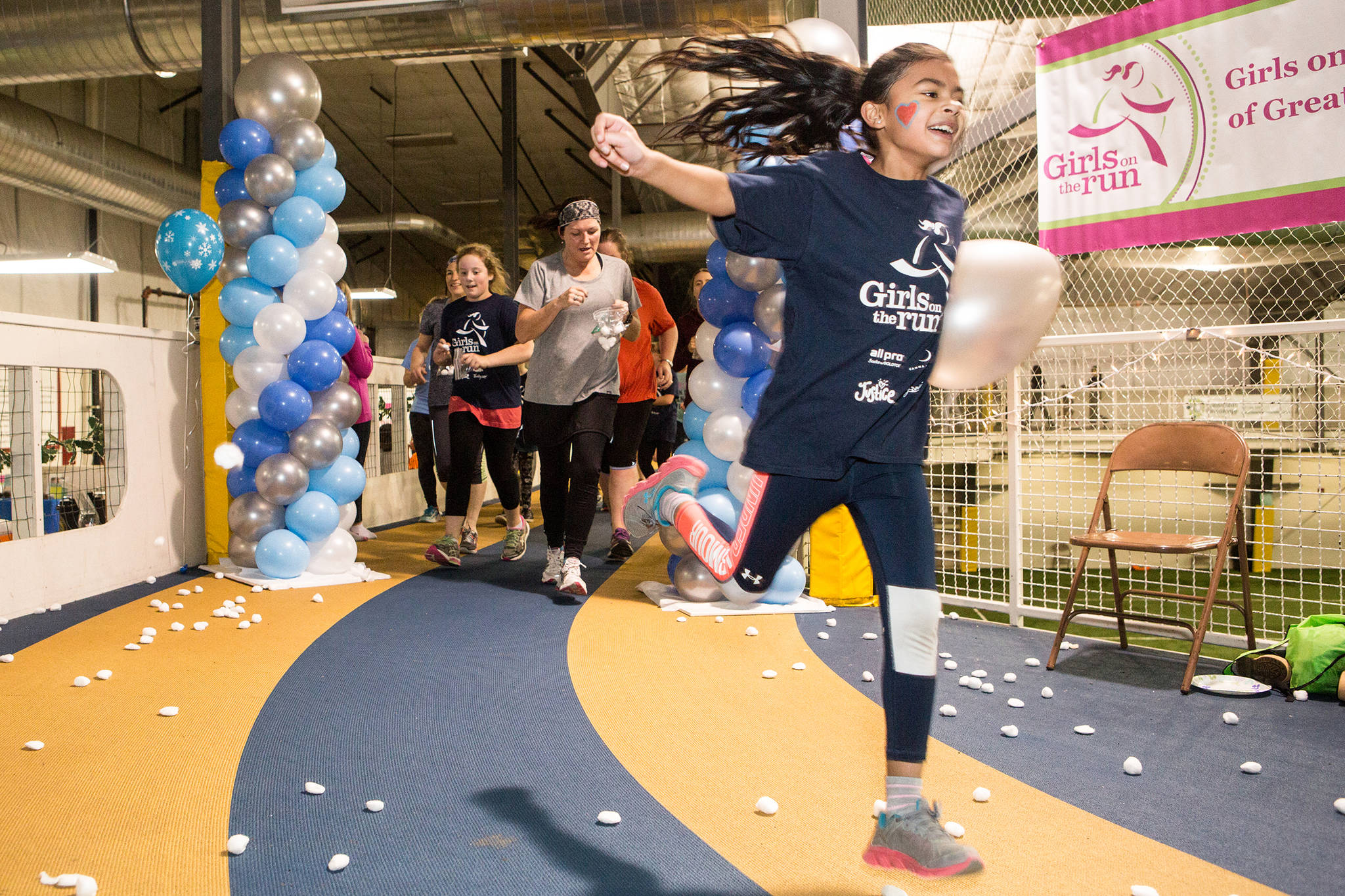 Girls on the Run participant Anjali Padhi soars around the track during a 5-kilometer run in the Wells Fargo Dimond Park Field House in December. (Courtesy Photo | Natalie Watson)