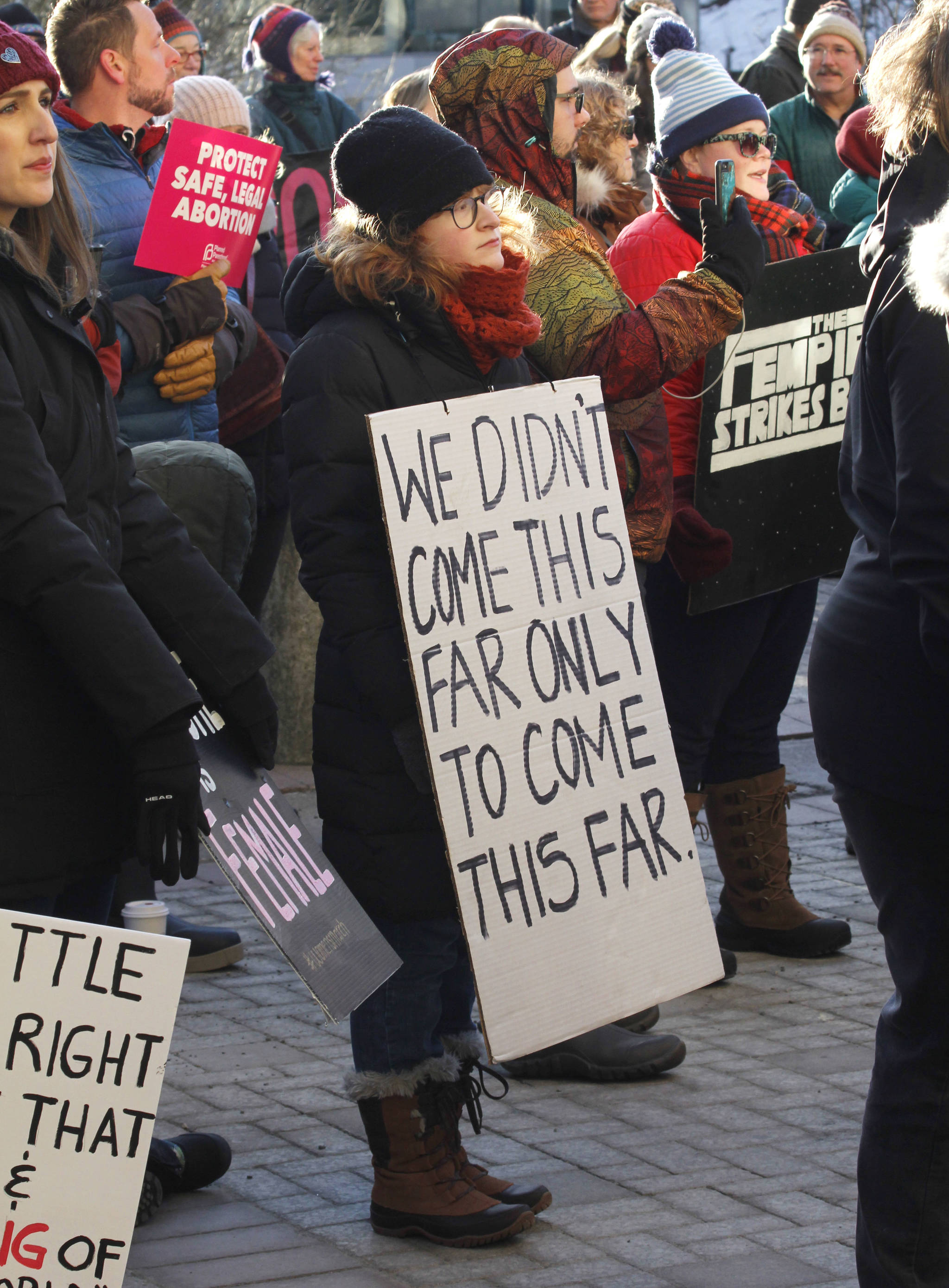 Attendees hold up signs at Juneau’s Women’s March on Saturday, Jan. 19, 2019. (Alex McCarthy | Juneau Empire)