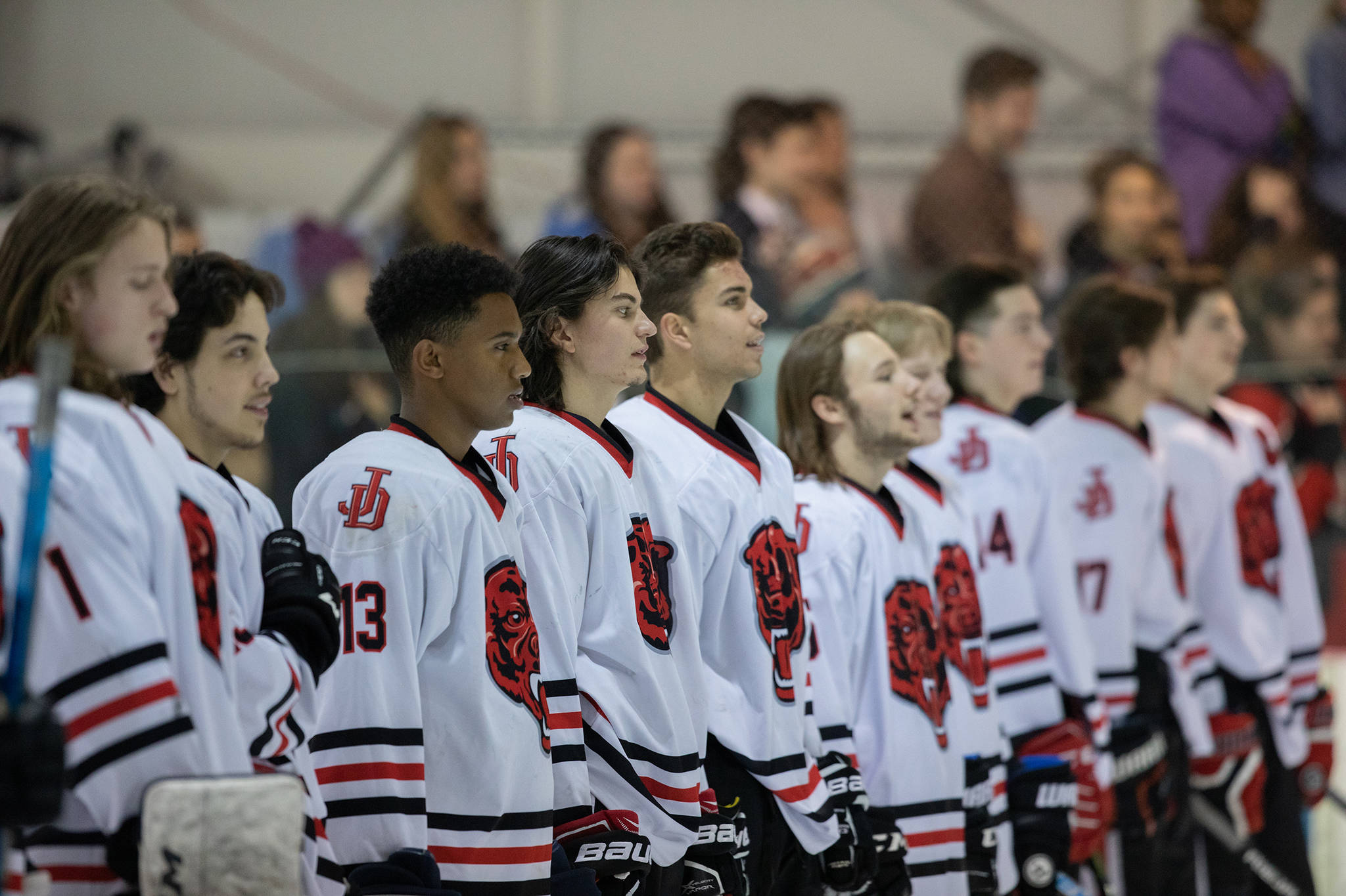The Juneau-Douglas High School hockey team sings the national anthem prior to its game against Homer at Treadwell Arena on Saturday, Jan. 20, 2019. JDHS coaches Luke Adams and Matt Boline honored 12 seniors prior to the start of the game, the final varsity home match of the season. (Courtesy Photo | Carol Lahnum/CrowFoxPhotography.com)