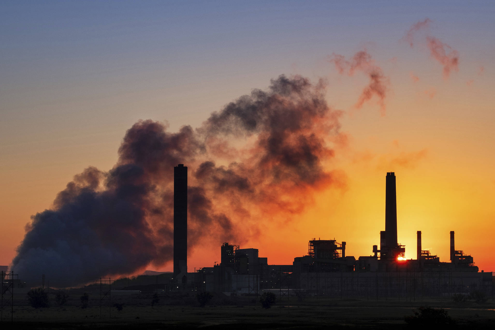 In this July 27, 2018 photo, the Dave Johnson coal-fired power plant is silhouetted against the morning sun in Glenrock, Wyoming. (J. David Ake | Associated Press File)