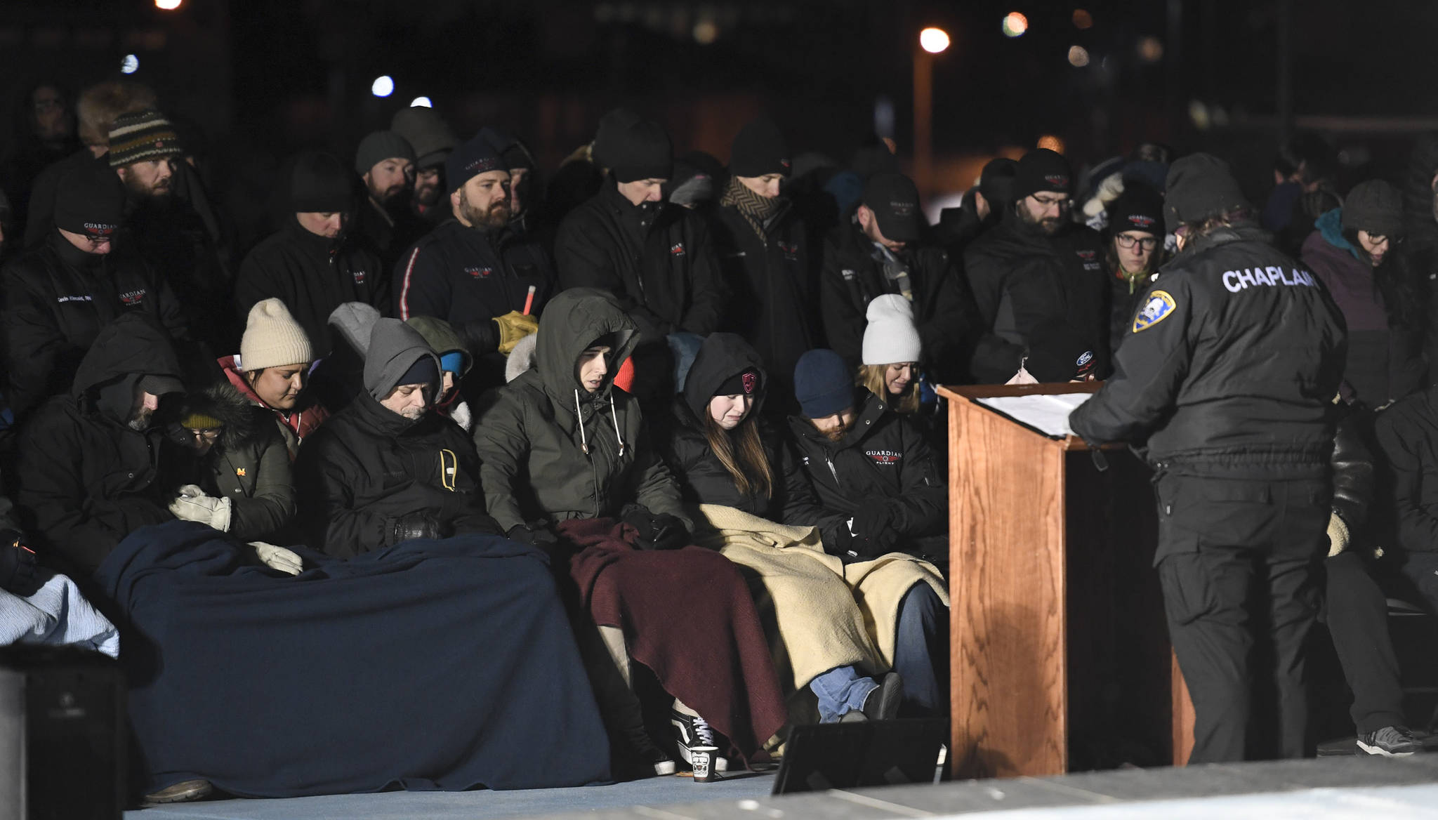 Alaska Police and Fire Chaplain Diane Peterson leads a candlelight vigil at the Mayor Bill Overstreet Park for the Guardian medical flight crew that went missing this week. (Michael Penn | Juneau Empire)