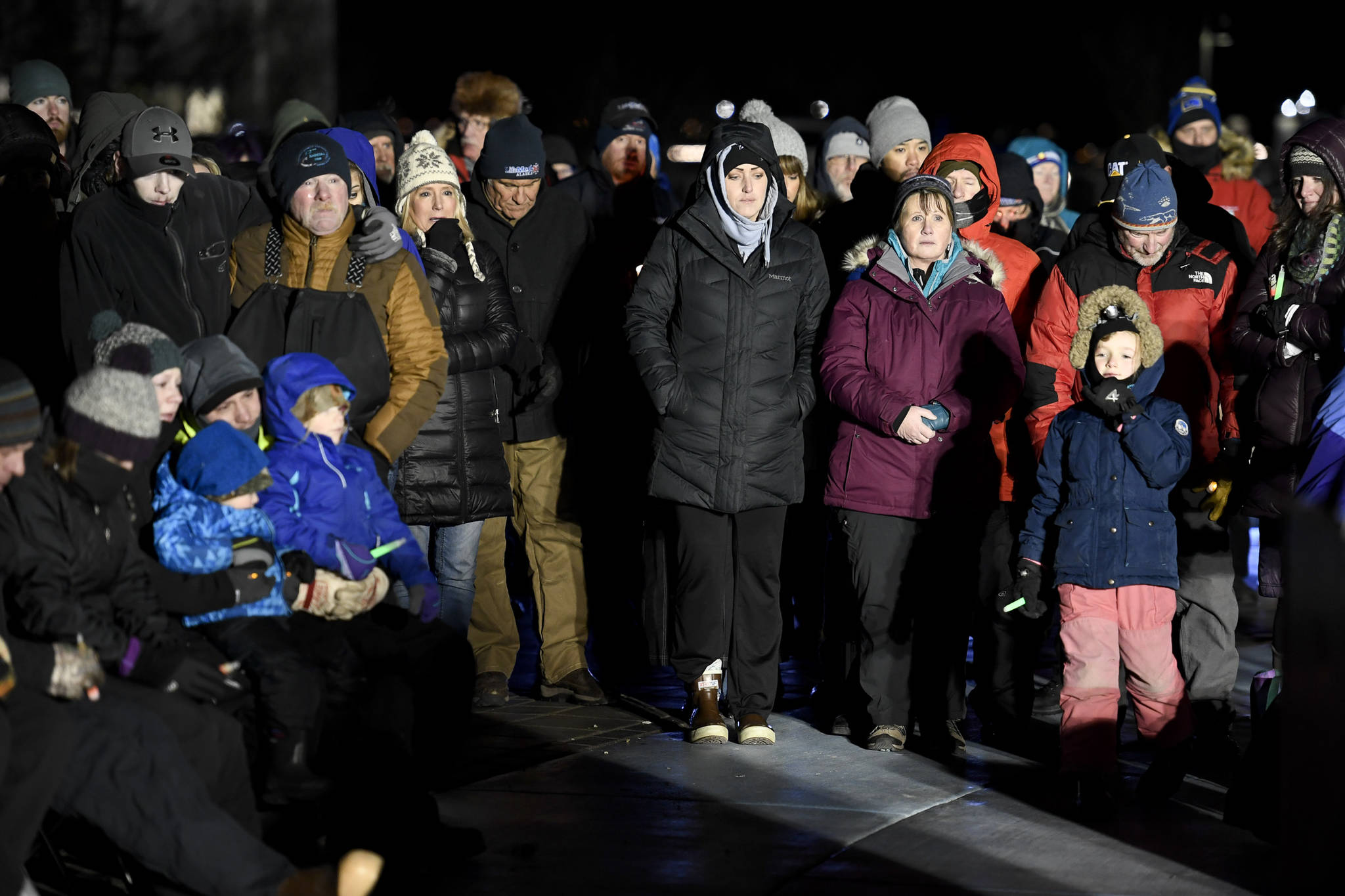 Hundreds of Juneau residents turnout Friday, Feb. 1, 2019, in 8-degree weather for a candlelight vigil at Mayor Bill Overstreet Park for the Guardian medical flight crew that went missing this week. (Michael Penn | Juneau Empire)