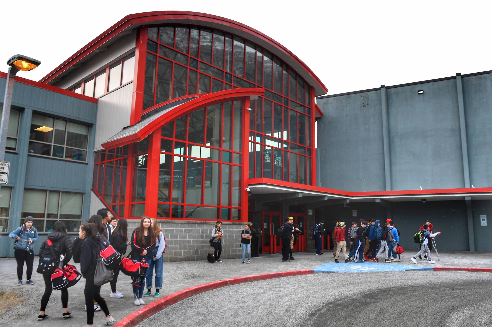 Juneau-Douglas High School students wait for rides home after malfunctioning boiler caused the school to close early on Monday, Feb. 4, 2019. (Michael Penn | Juneau Empire)