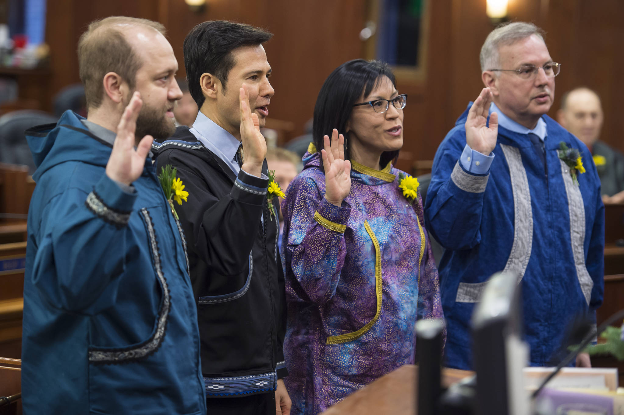 Rep. John Lincoln, D-Kotzebue, left, Rep. Neal Foster, D-Nome, Rep. Tiffany Zulkosky, D-Bethel, and Rep. Bryce Edgmon, D-Dillingham, right, wear kuspuks as they are sworn into their House seats on Tuesday, Jan. 15, 2019. (Michael Penn | Juneau Empire)