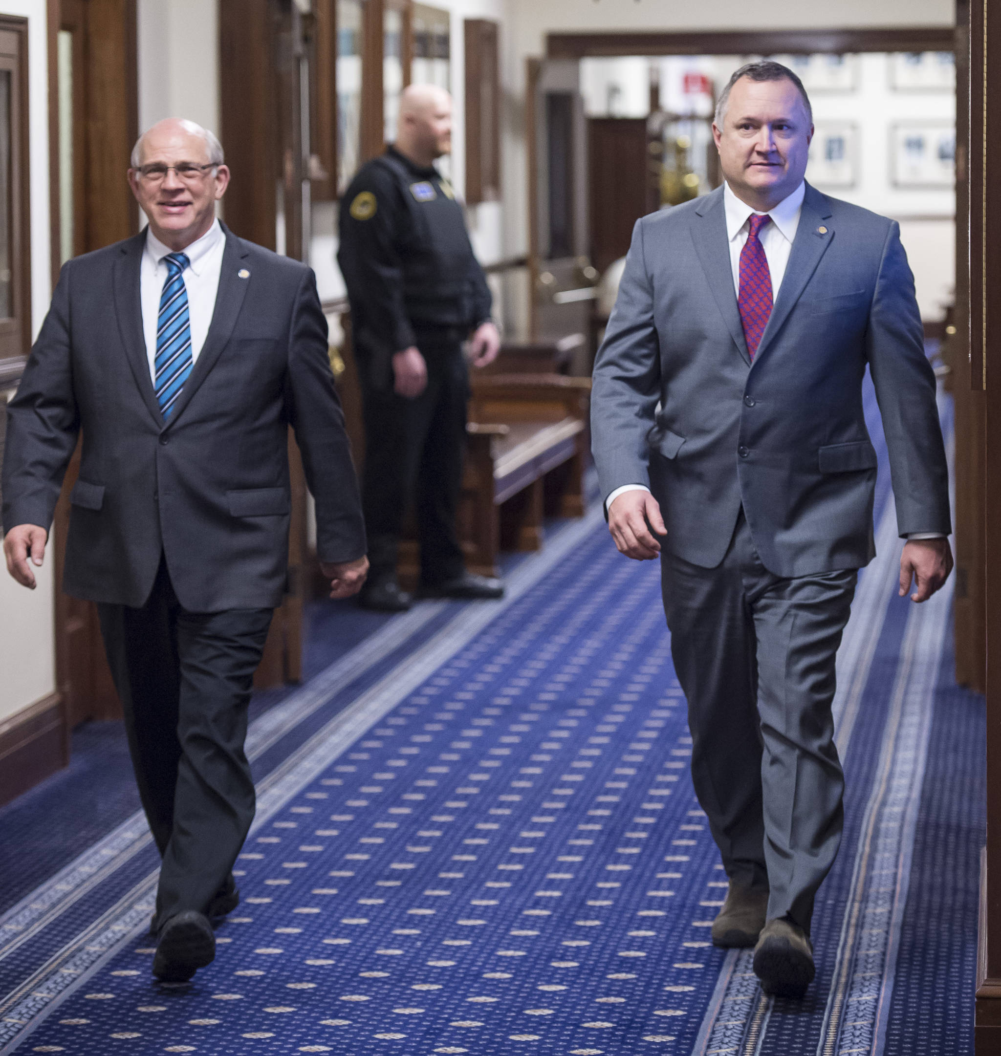 Sen. John Coghill, R-North Pole, left, and Sen. Mike Shower, R-Wasilla, power walk to attend Gov. Mike Dunleavy’s State of the State speech to a Joint Session of the Alaska Legislature on Tuesday, Jan. 22, 2019. (Michael Penn | Juneau Empire)