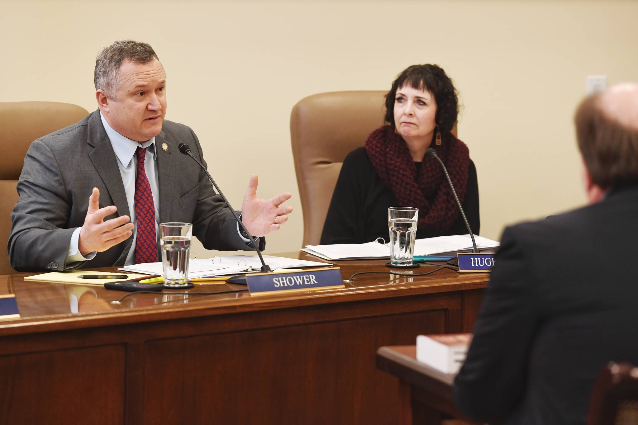 Senate Judiciary Committee member Sen. Mike Shower, R-Wasilla, left, asks a question of Attorney General Kevin Clarkson about Gov. Mike Dunleavy’s four crime bills as Sen. Shelley Hughes, R-Wasilla, listens at the Capitol on Wednesday, Feb. 6, 2019. (Michael Penn | Juneau Empire)