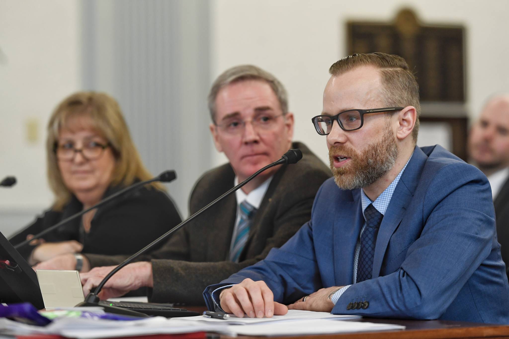 Andy Jones, Director of the Department of Health and Social Services’ Office of Substance Misuse, right, speak about the fiscal impacts of the opioids on the state along with Michael Duxbury, Deputy Commissioner of the Department of Public Safety, center, and Laura Brooks, Director of Health and Rehabilitation for the Department of Corrections, in front of the Senate Finance Committee on Thursday, Feb. 7, 2019. (Michael Penn | Juneau Empire)