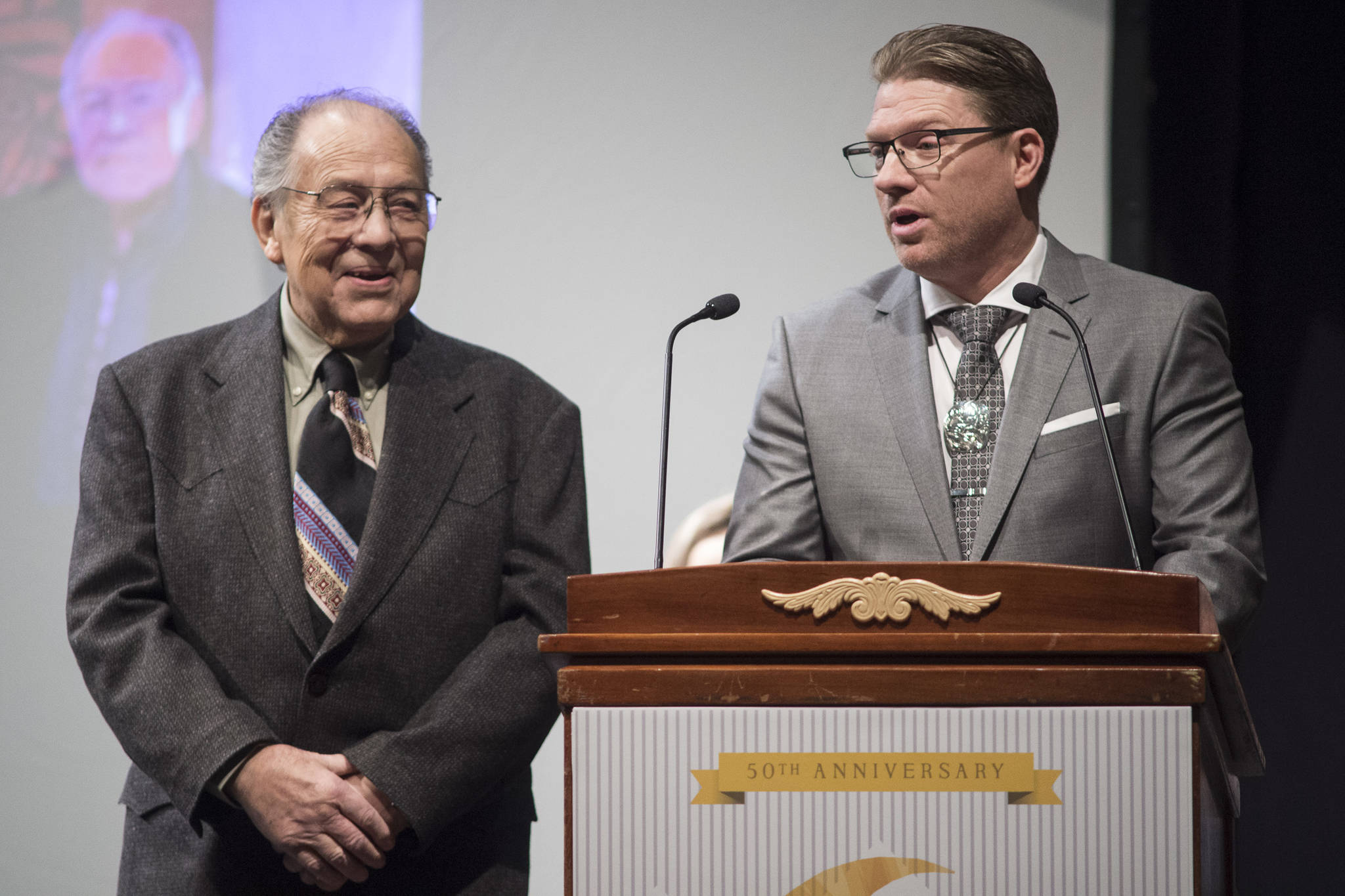 Jack Hudson, left, and his son, John Hudson III, of Metlakatla, give their thank you speech after winning the Alaska Native Arts Award at the 2019 Governor’s Arts and Humanities Awards at the Juneau Arts & Culture Center on Thursday, Feb. 7, 2019. (Michael Penn | Juneau Empire)
