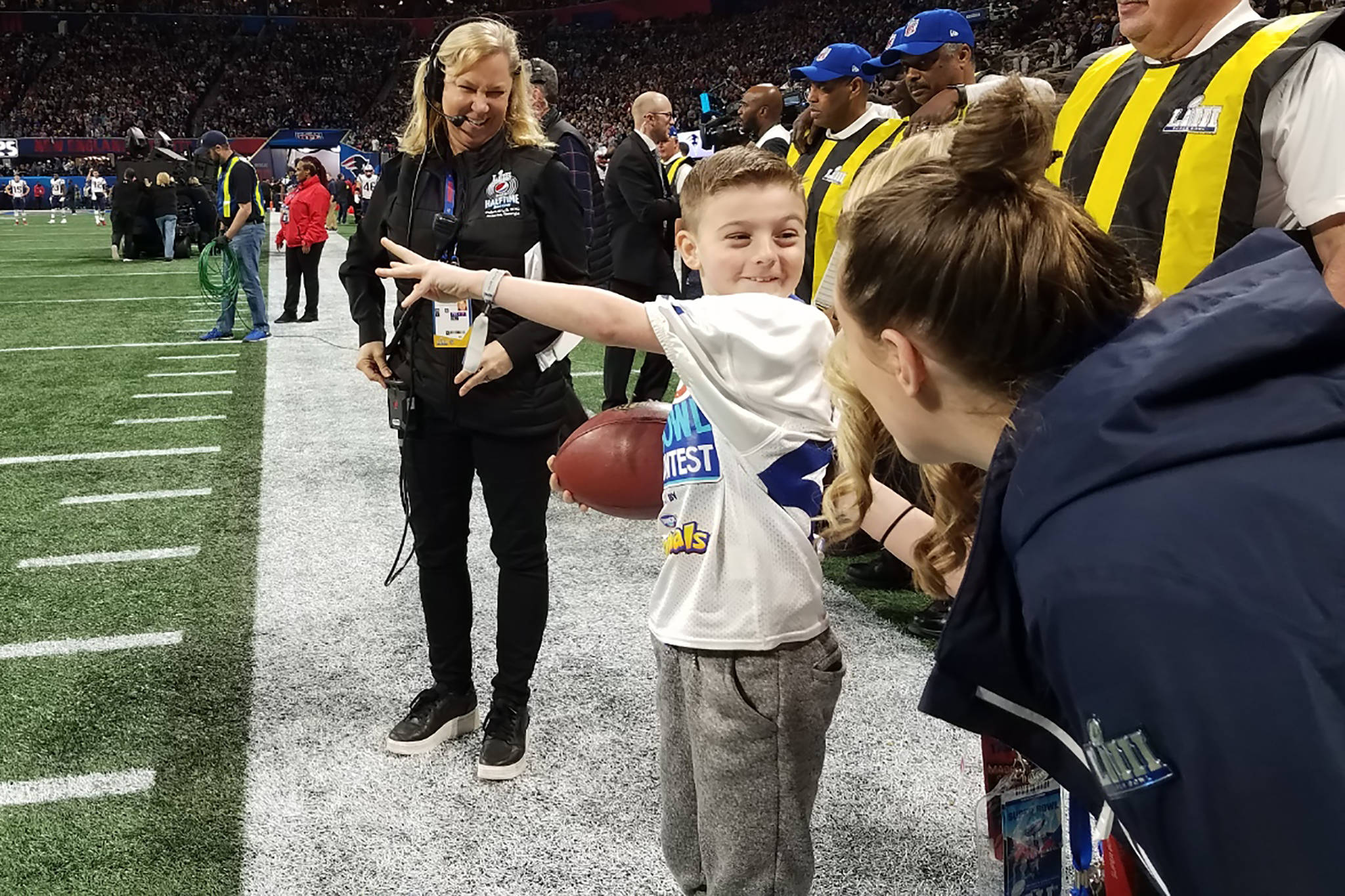 Camdyn Clancy, 8, prepares to deliver to the game ball to the Super Bowl LIII officiating crew at the Mercedes-Benz Stadium in Atlanta on Sunday, Feb. 3, 2019. The Juneau third-grader and Seattle Seahawks superfan won an all-expense paid trip to cover the big game as the grand prize winner of the NFL PLAY 60 Super Kid contest. (Courtesy Photo | Hannah Clancy)