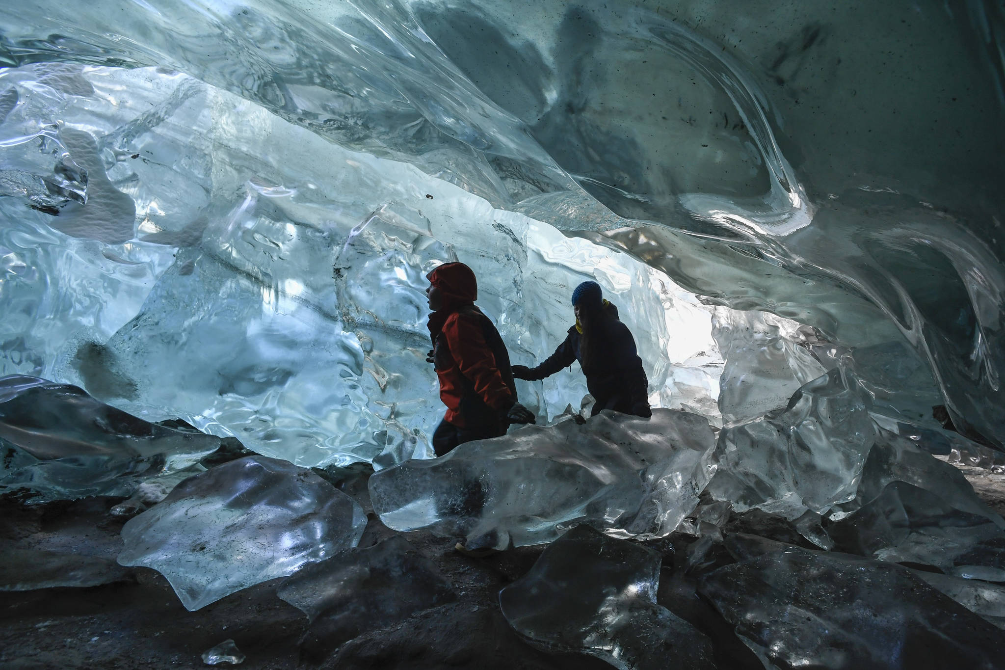 Alexia Keifer and her son, DJ, 8, explore an ice cave at the Mendenhall Glacier on Monday, Feb. 11, 2019. (Michael Penn | Juneau Empire)