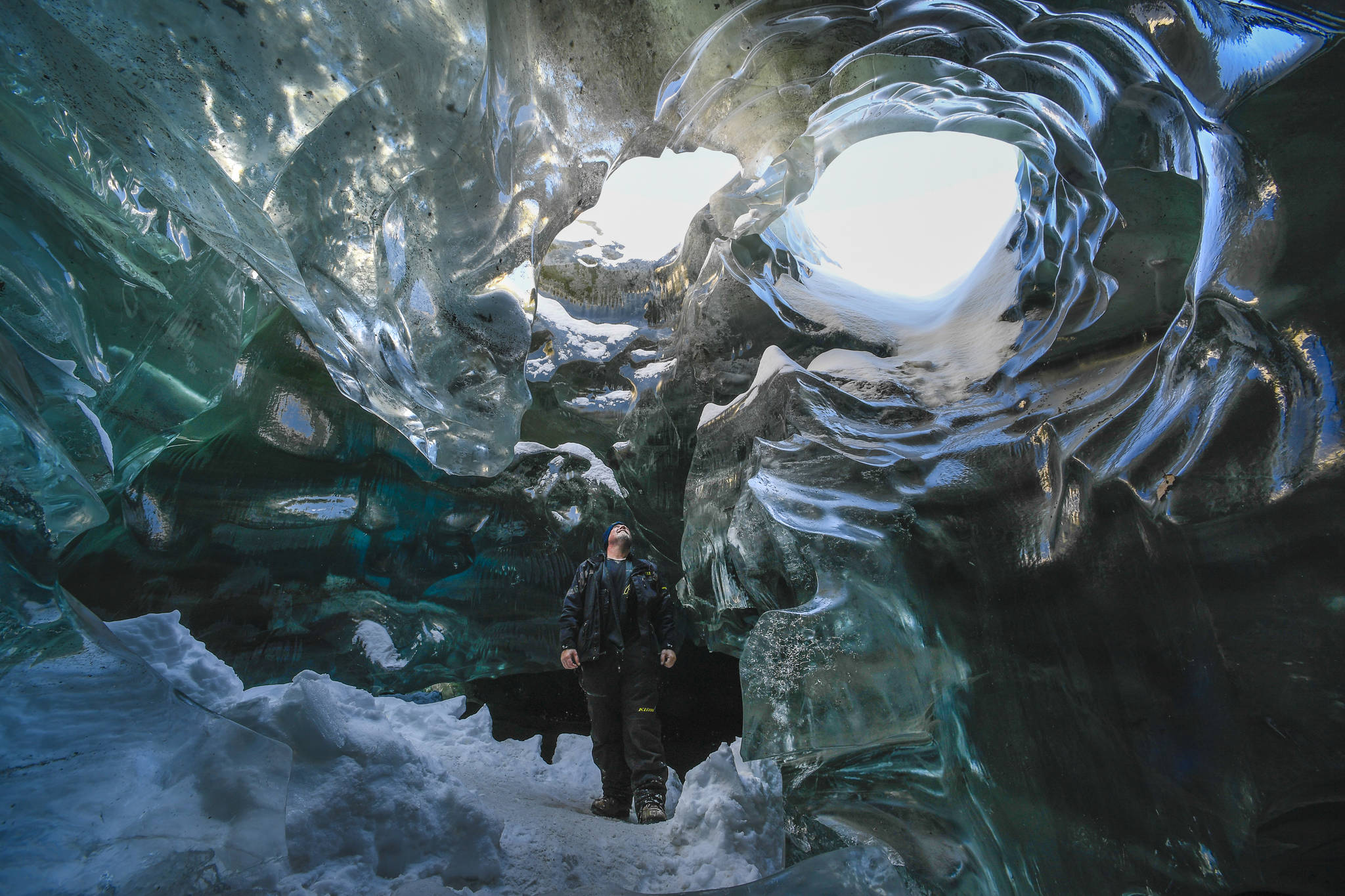 Shawn Lovell explores an ice cave at the Mendenhall Glacier on Monday, Feb. 11, 2019. (Michael Penn | Juneau Empire)