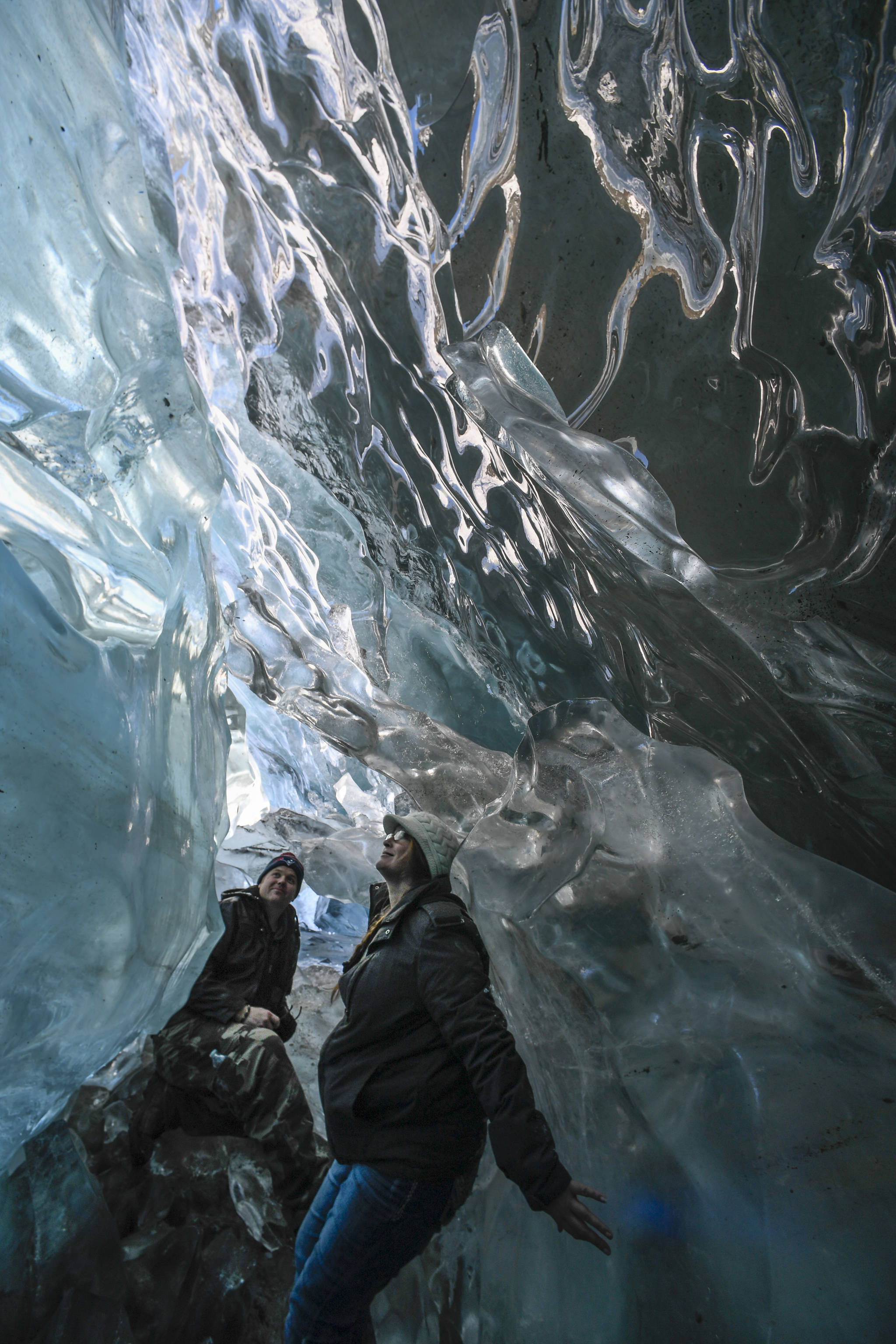 Helen Rice and her husband, Jason Writesel, visiting from Ohio, explore an ice cave at the Mendenhall Glacier on Monday, Feb. 11, 2019. (Michael Penn | Juneau Empire)