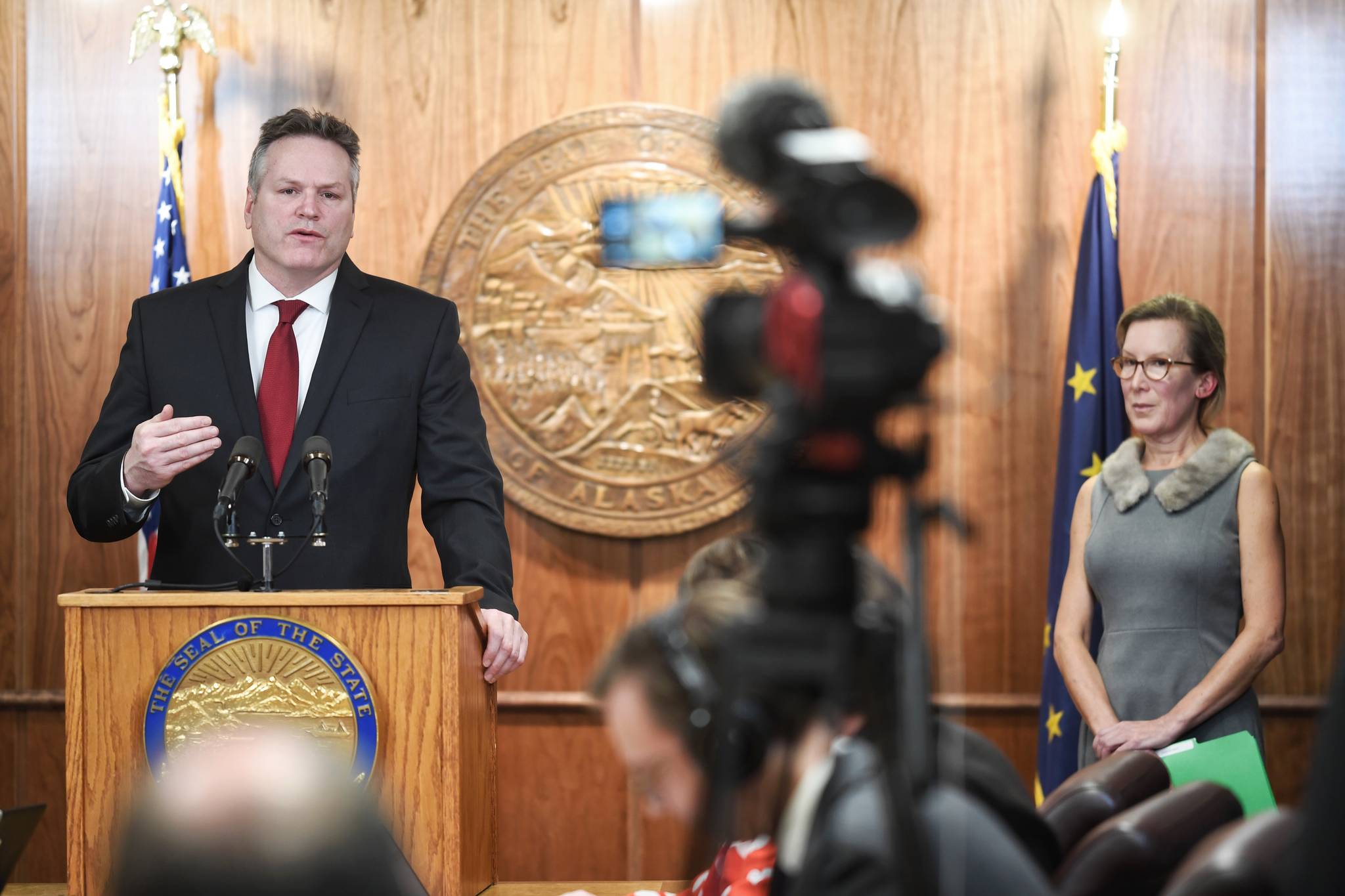 Gov. Mike Dunleavy speaks about his budget as OMB Director Donna Arduin listens during a press conference to announce the state’s budget on Wednesday, Feb. 13, 2019. (Michael Penn | Juneau Empire)