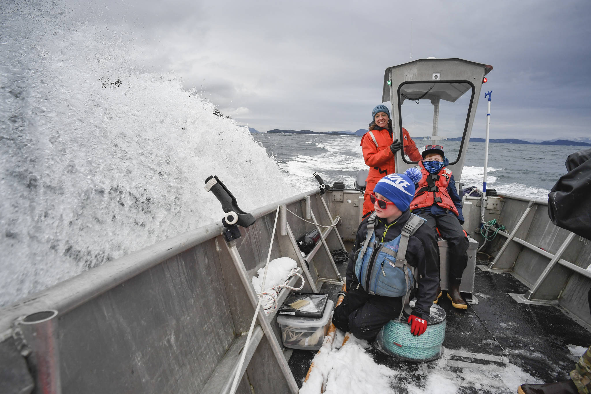 Meta Mesdag, with her sons Kai, 8, and Emmett, 11, take an open skiff in Lynn Canal to their oyster farm in Bridget Cove on Tuesday, Feb. 12, 2019. (Michael Penn | Juneau Empire)
