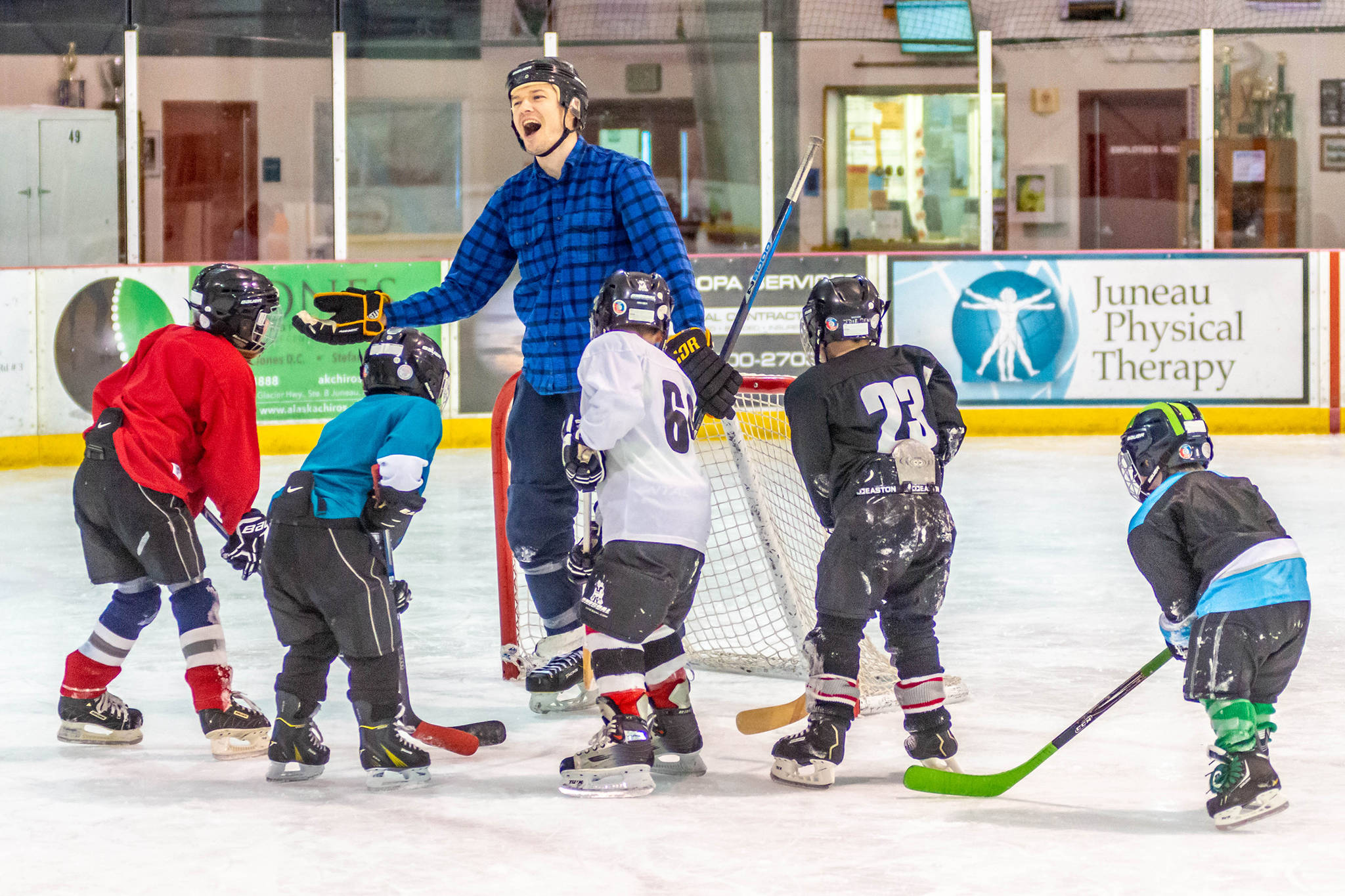 Coach Alec Venechuk shares a laugh with a group of players during a recent practice at Treadwell Ice Arena. (Courtesy Photo | Steve Quinn)
