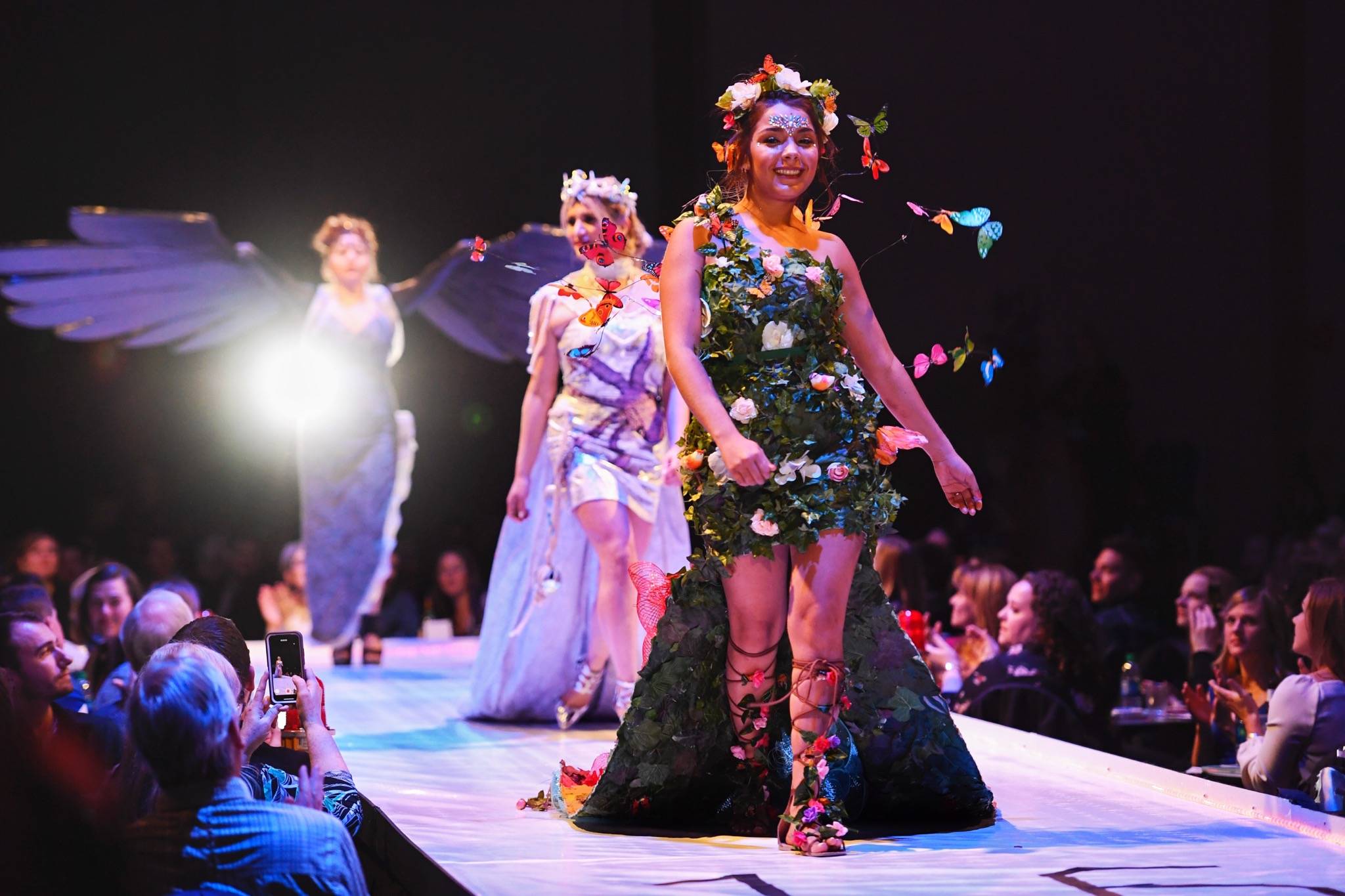 Maleny Villagomez, Samantha Harrison and Tesa Castillo work the runway with the piece “Protect What is Sacred” at the Wearable Art show at Centennial Hall on Saturday, Feb. 16, 2019. The artists are Paty Villagomez and Glo Ramirez. (Michael Penn | Capital City Weekly)