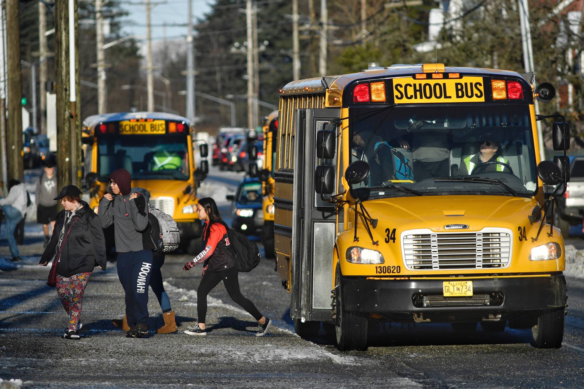 Buses deliver students to Juneau-Douglas High School: Yadaa.at Kalé on Wednesday, Feb. 20, 2019. The Juneau School District is facing cuts to next year’s budget that may lead to the layoffs of over 100 staff. (Michael Penn | Juneau Empire)